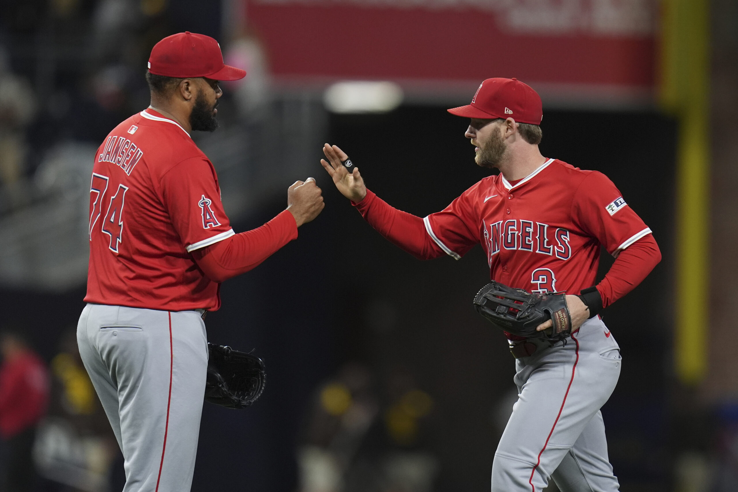 Angels designated hitter Taylor Ward, right, celebrates with relief pitcher...