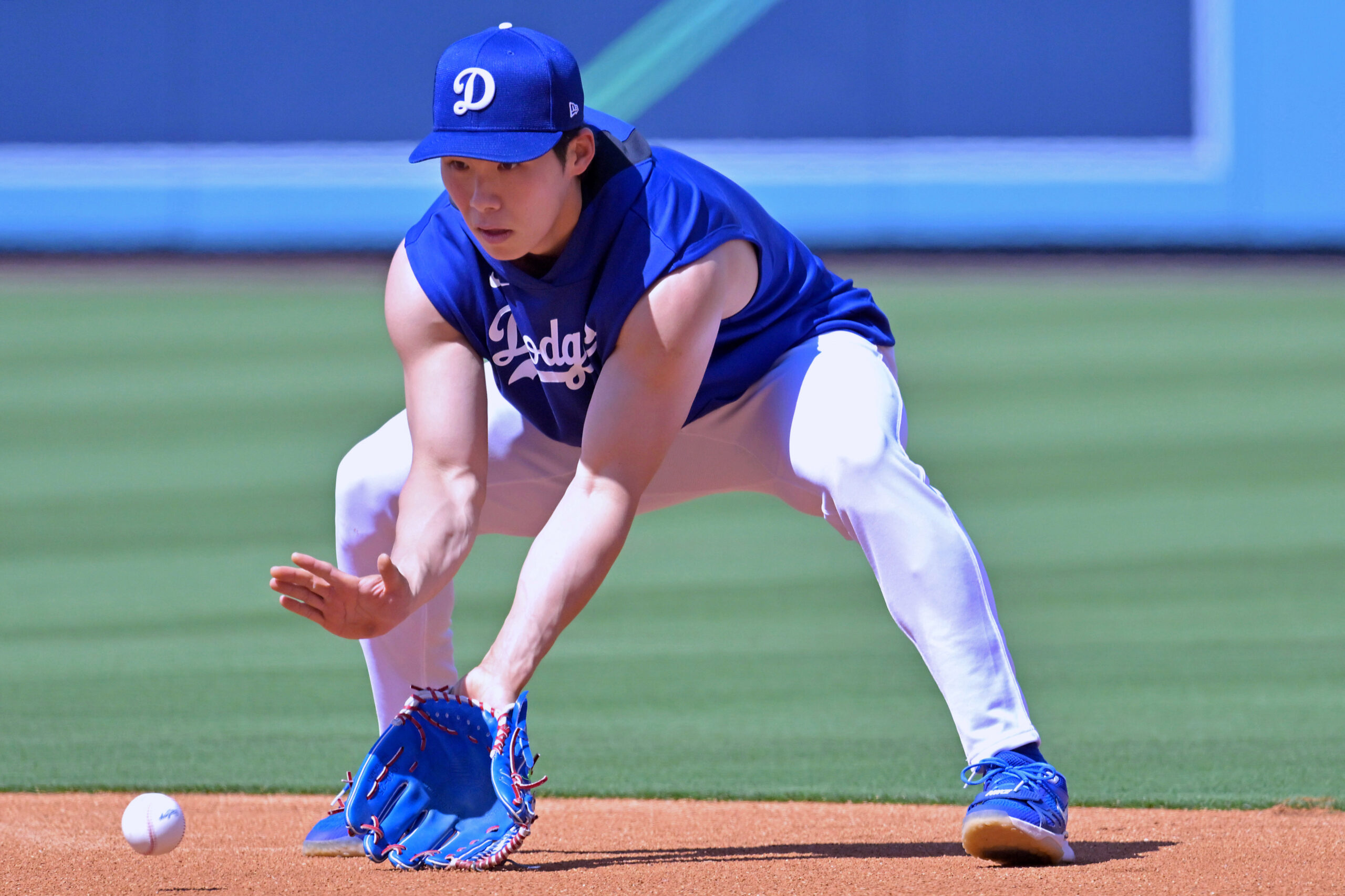Dodgers infielder Hyeseong Kim fields ground balls as he warms...