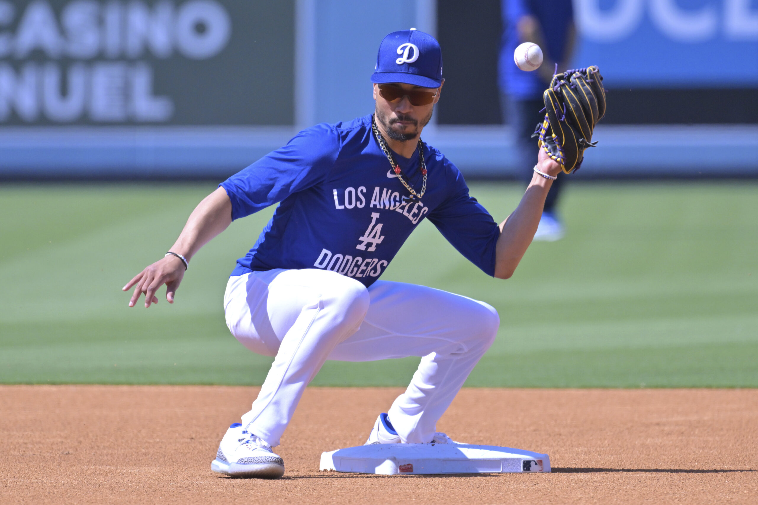 Dodgers shortstop Mookie Betts takes fielding practice as he warms...