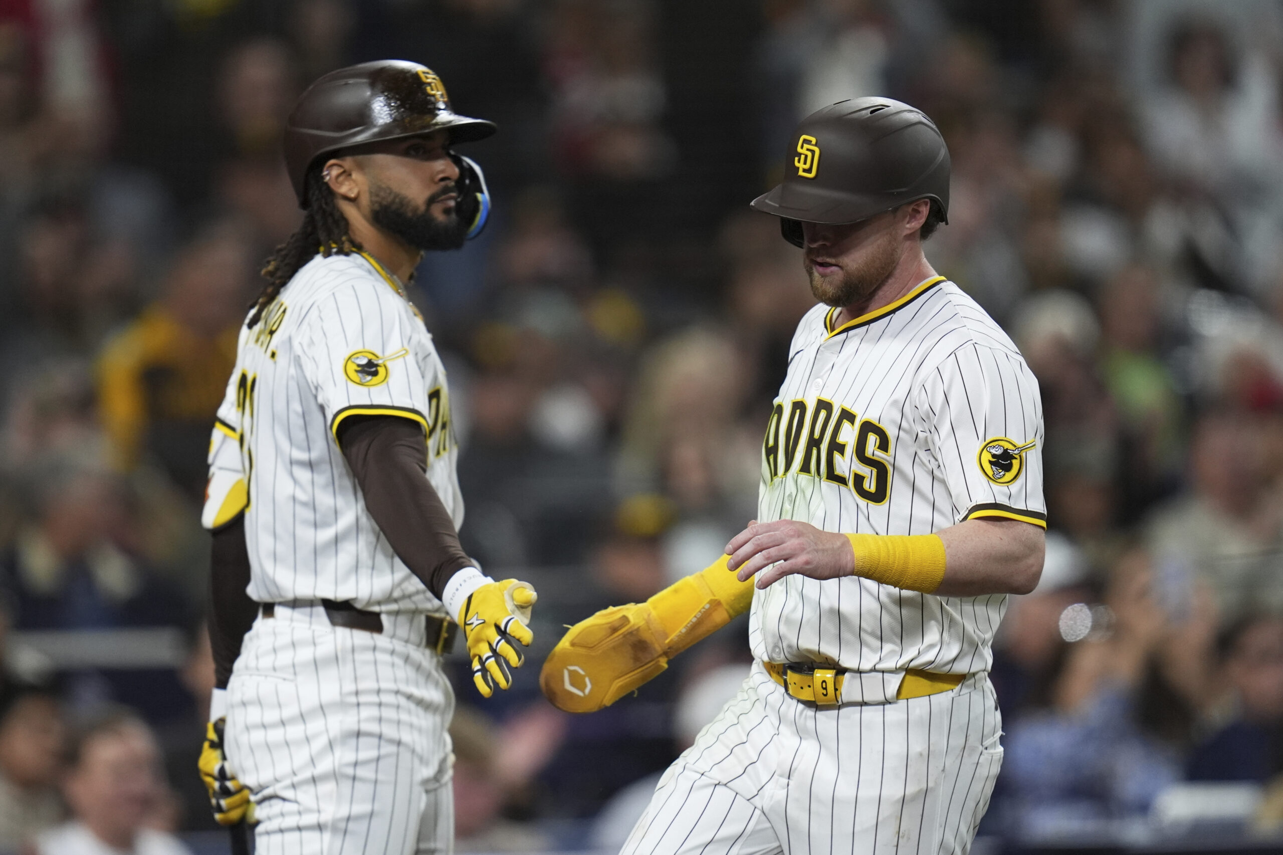 The San Diego Padres’ Jake Cronenworth, right, celebrates with teammate...