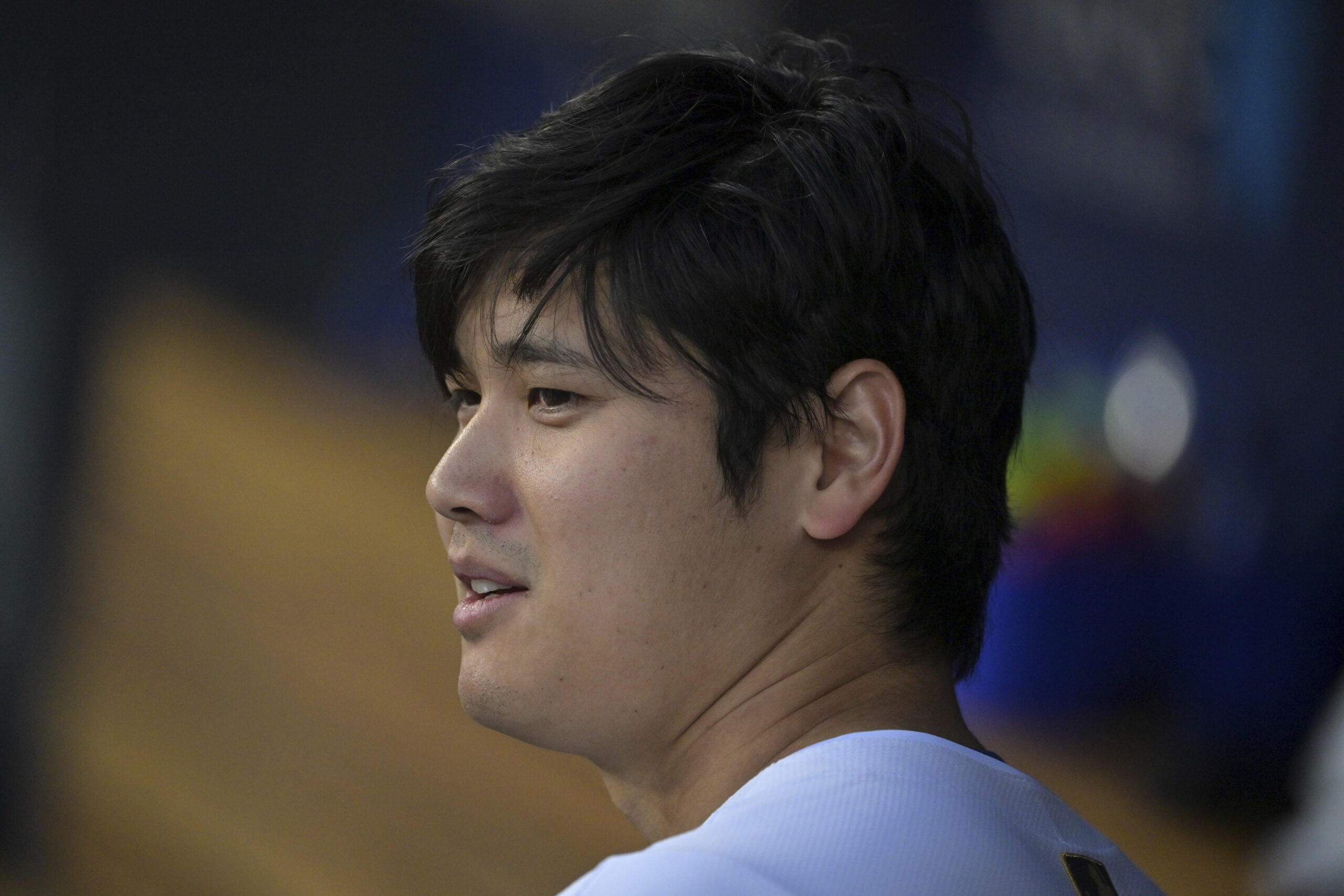 Dodgers star Shohei Ohtani looks on from the dugout during...