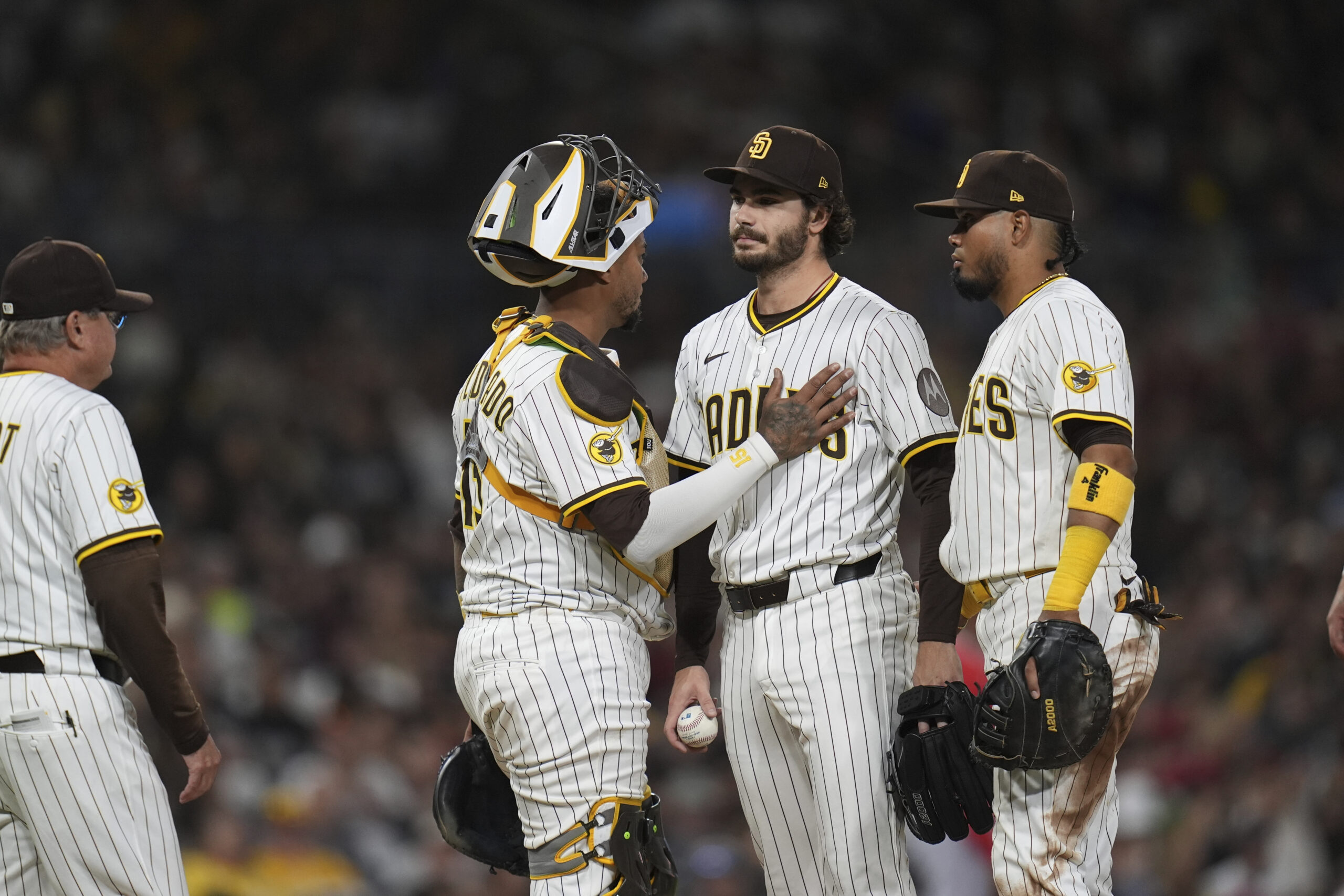 San Diego Padres catcher Martin Maldonado, center, pats starting pitcher...