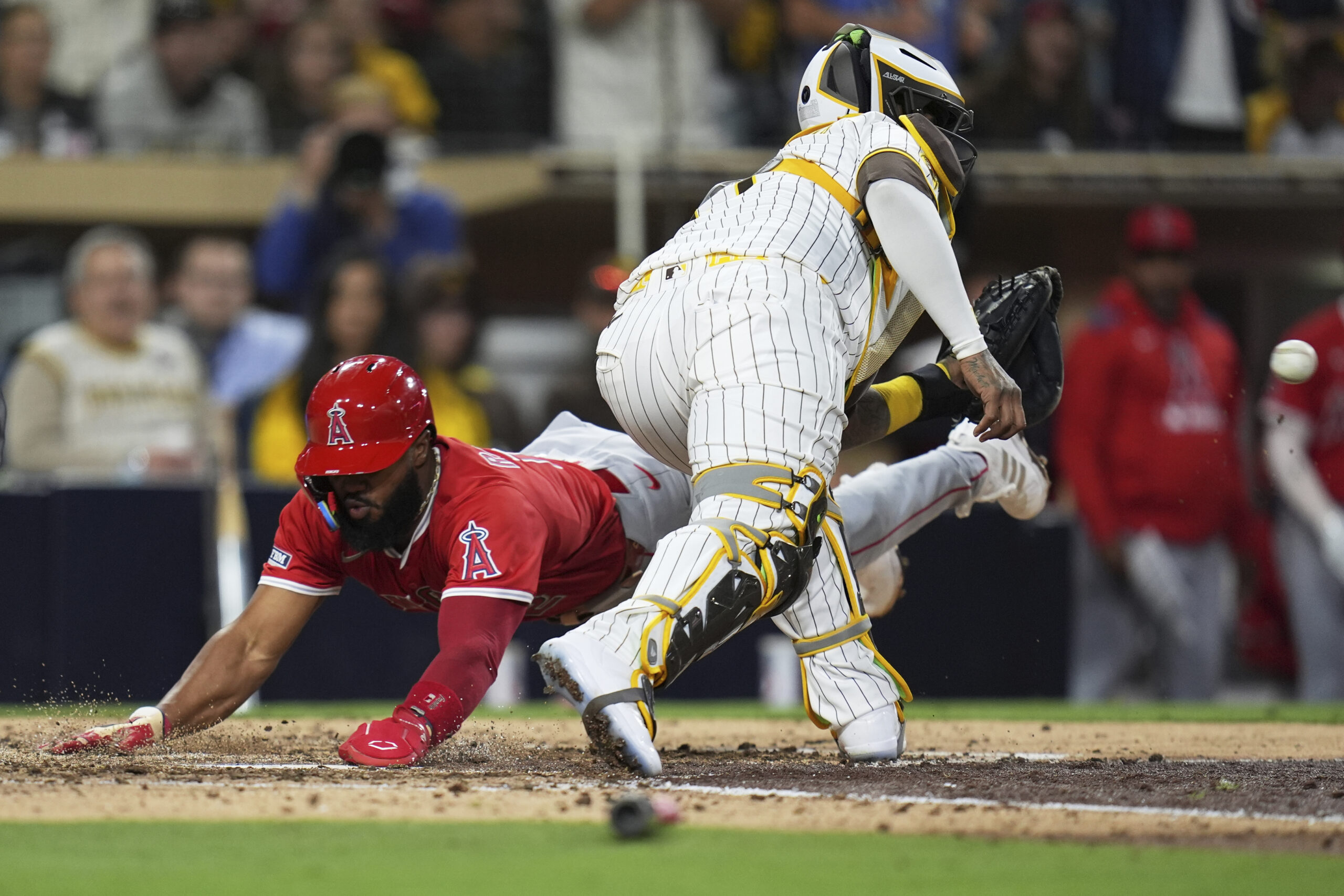 The Angels’ Luis Rengifo, left, scores from first on a...