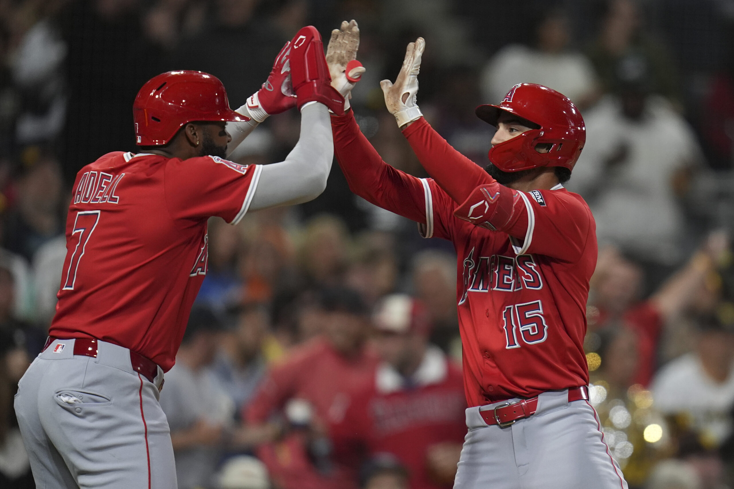 The Angels’ Matthew Lugo, right, celebrates with teammate Jo Adell...