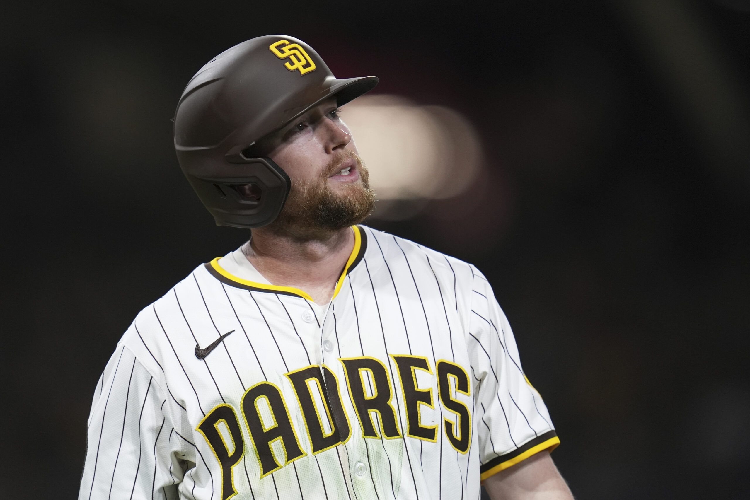 The San Diego Padres’ Jake Cronenworth looks on after flying...