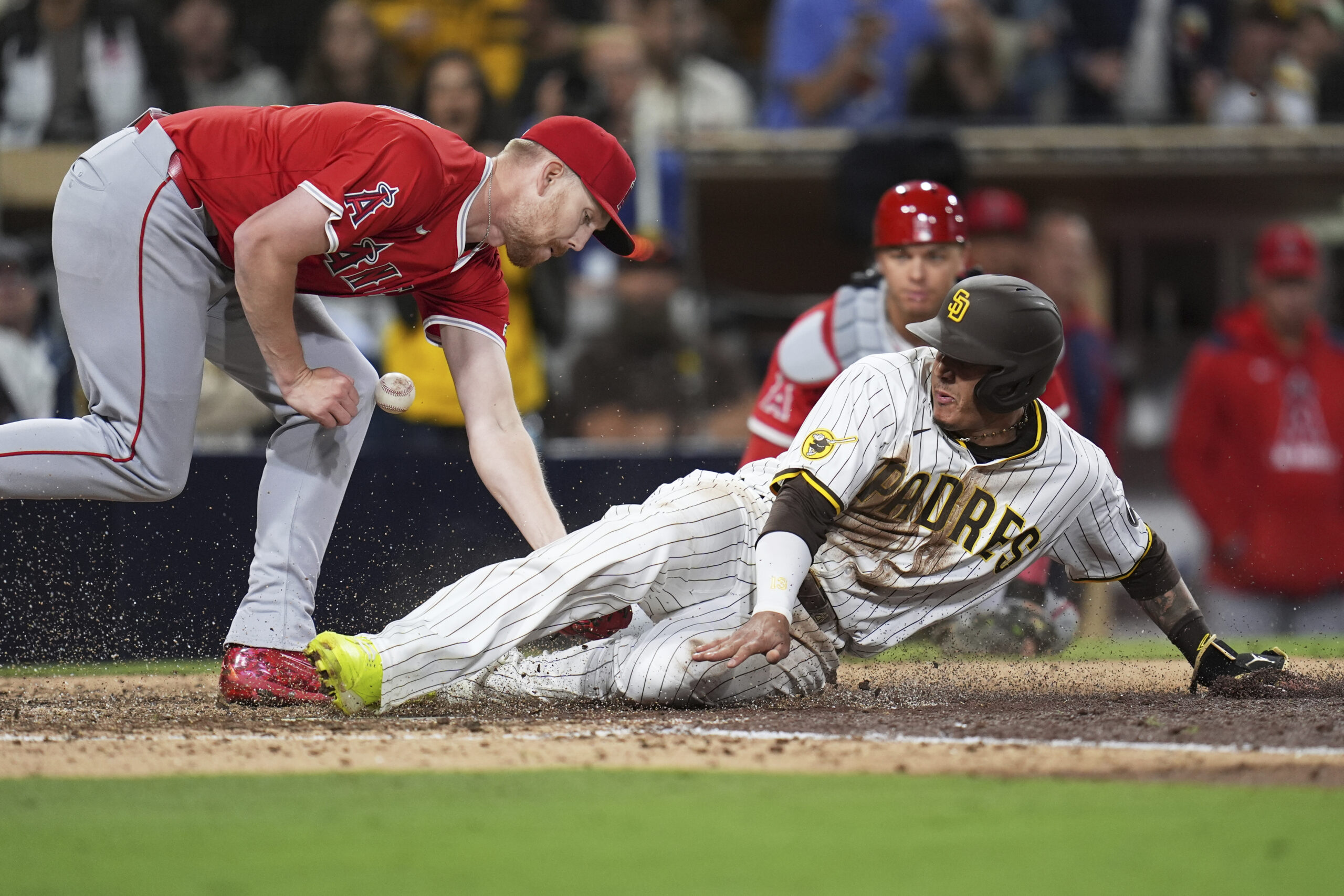 The San Diego Padres’ Manny Machado, right, scores on a...