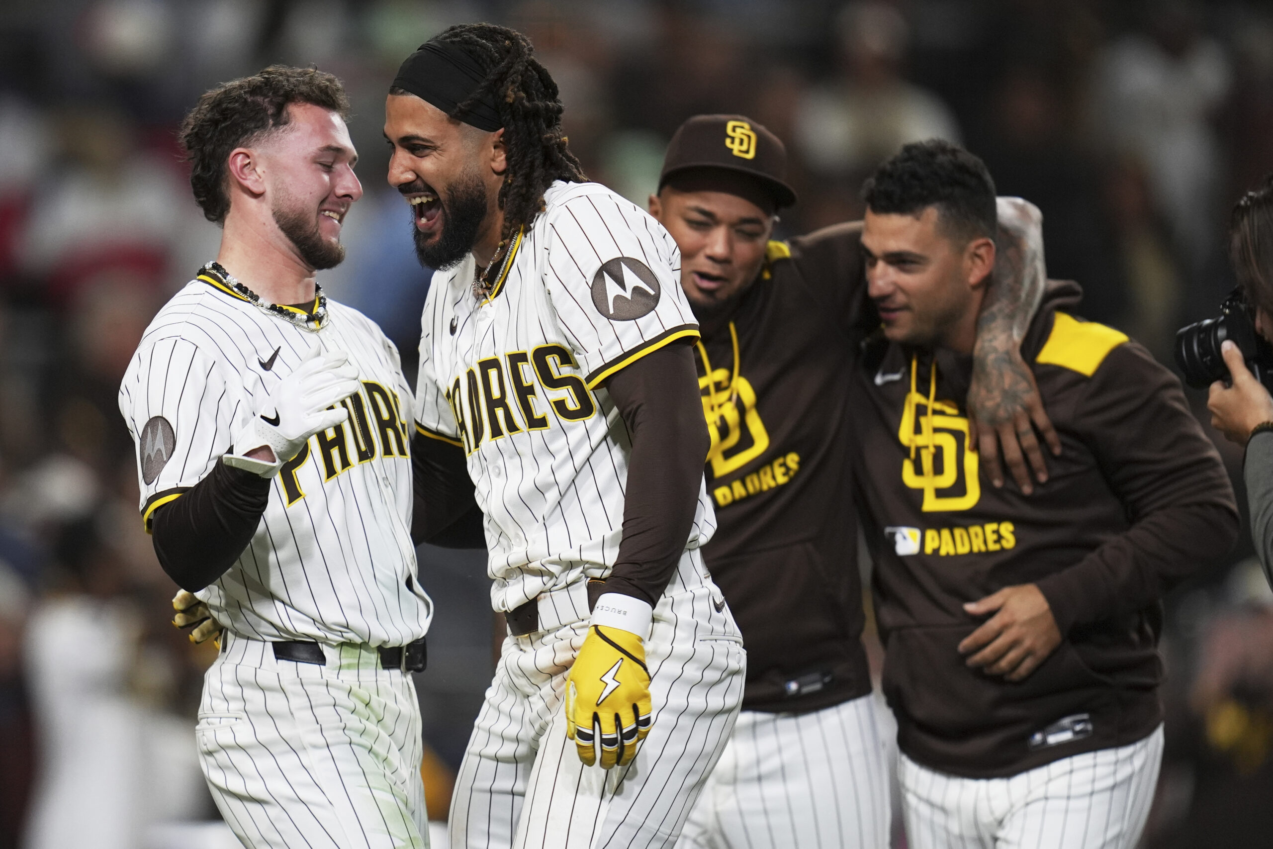 San Diego Padres star Fernando Tatis Jr., center left, celebrates...