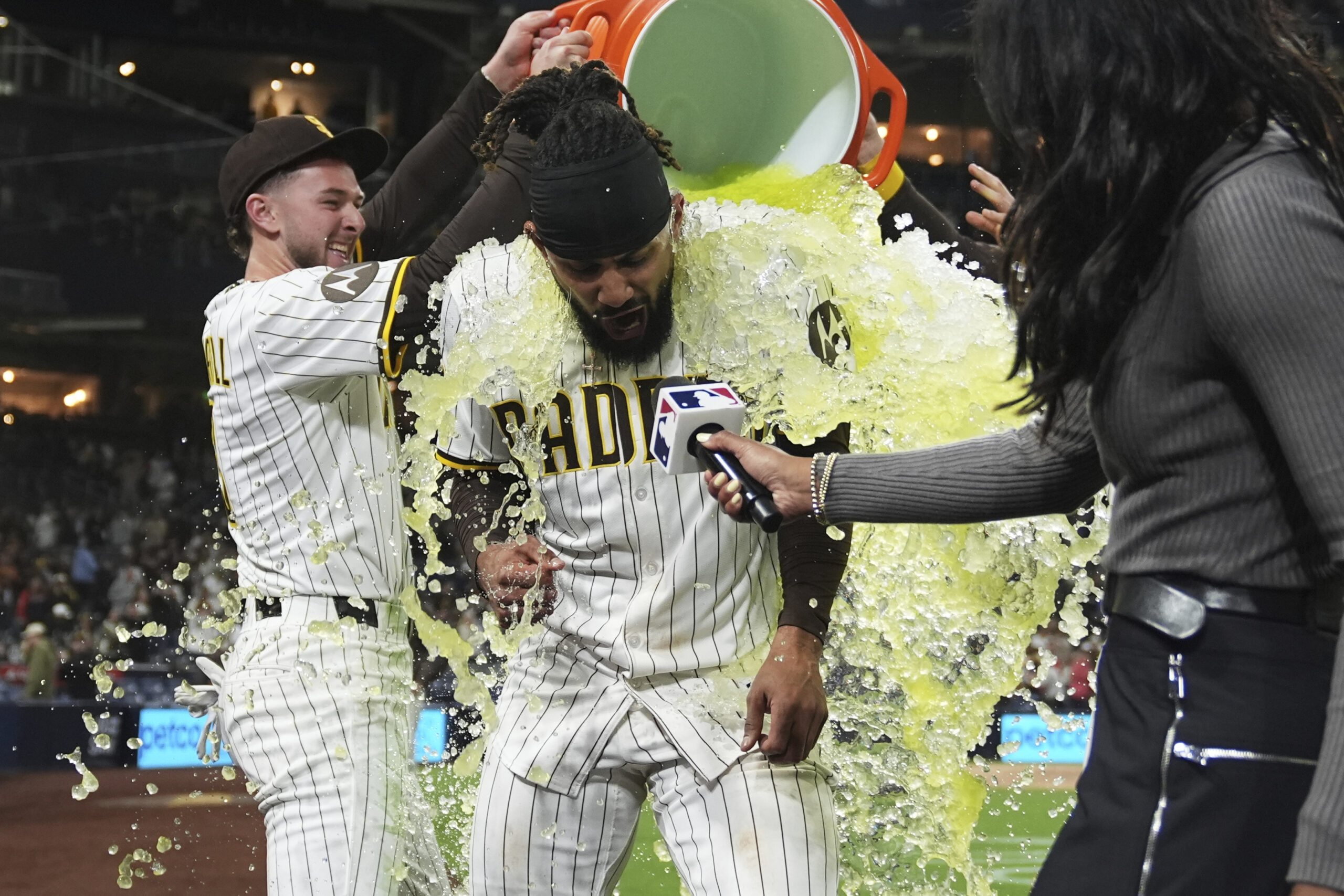 San Diego Padres star Fernando Tatis Jr., center, is doused...