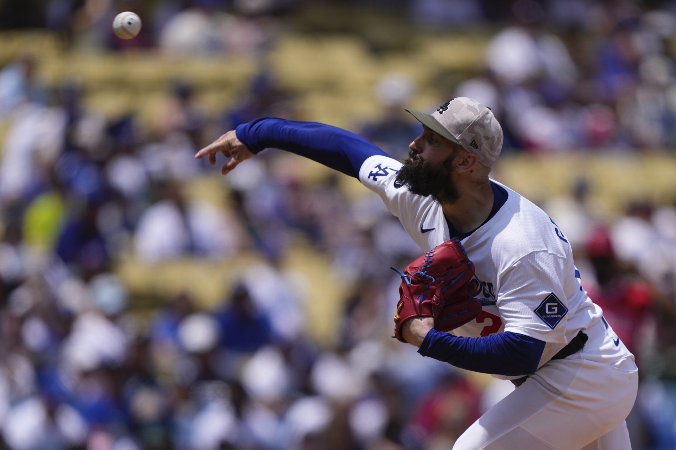 Dodgers starting pitcher Tony Gonsolin throws to the plate during...