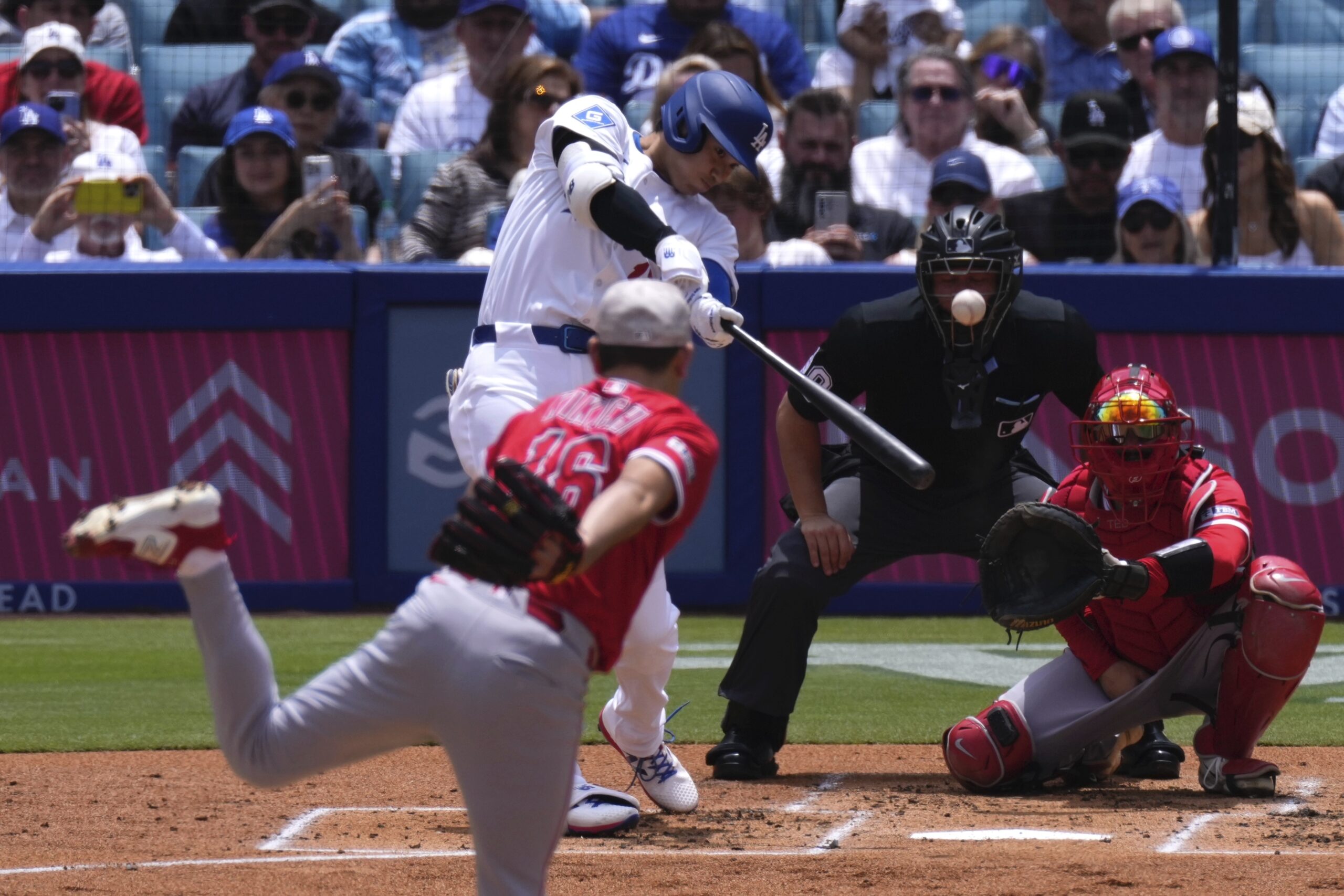 Angels starting pitcher Yusei Kikuchi, left, pitches to Dodgers’ Shohei...