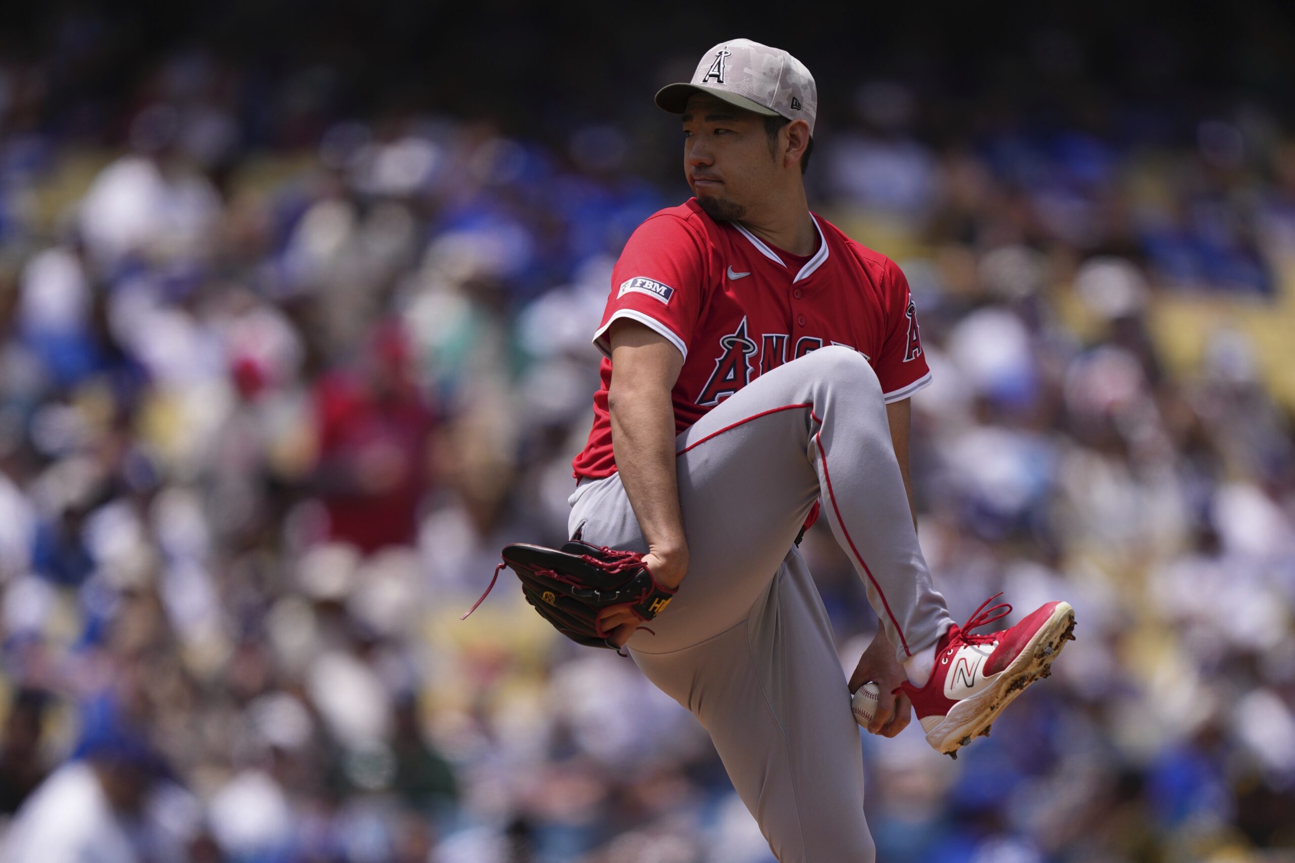 Angels starting pitcher Yusei Kikuchi throws to the plate during...