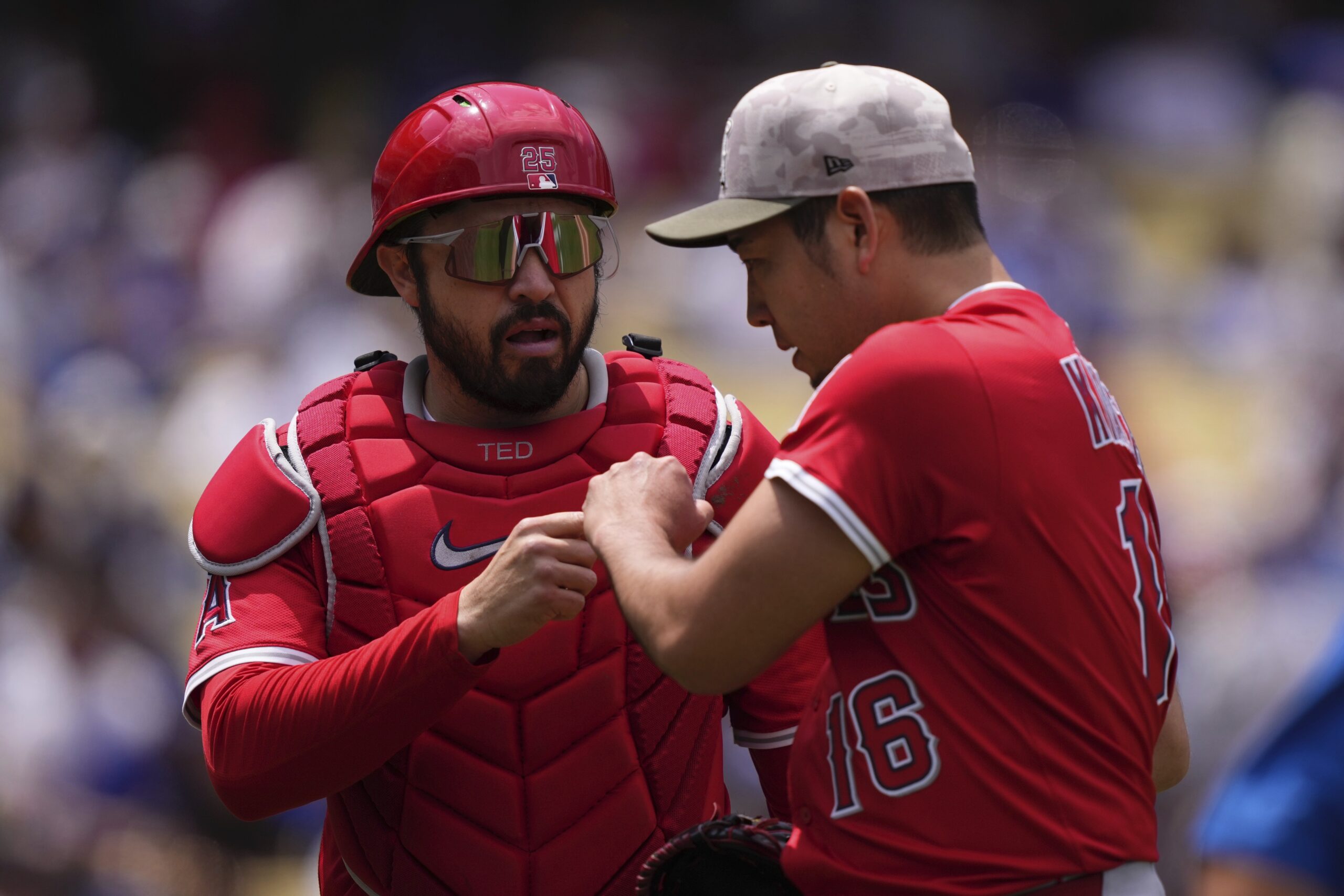 Angels catcher Travis d’Arnaud, left, and starting pitcher Yusei Kikuchi...