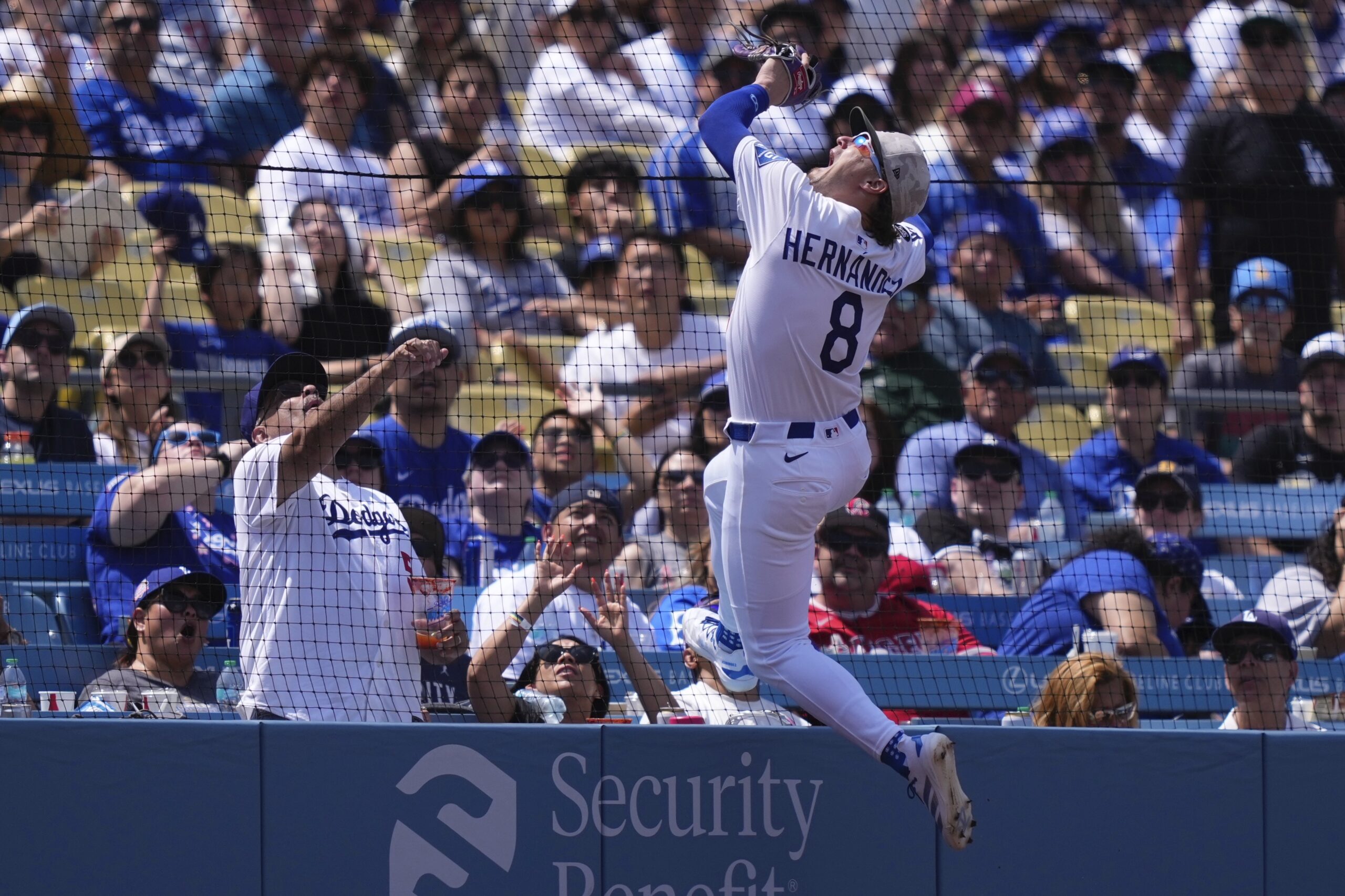 Dodgers first baseman Kiké Hernández can’t get to a foul...
