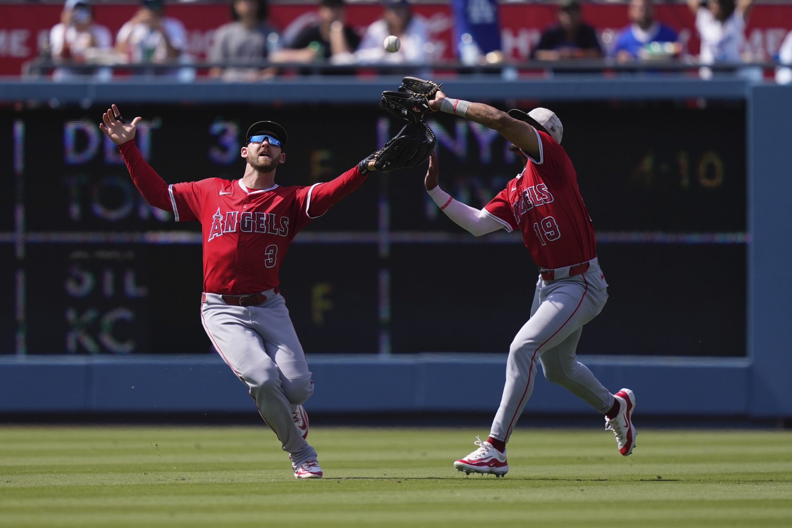 Angels’ Kyren Paris, right makes a catch on a ball...