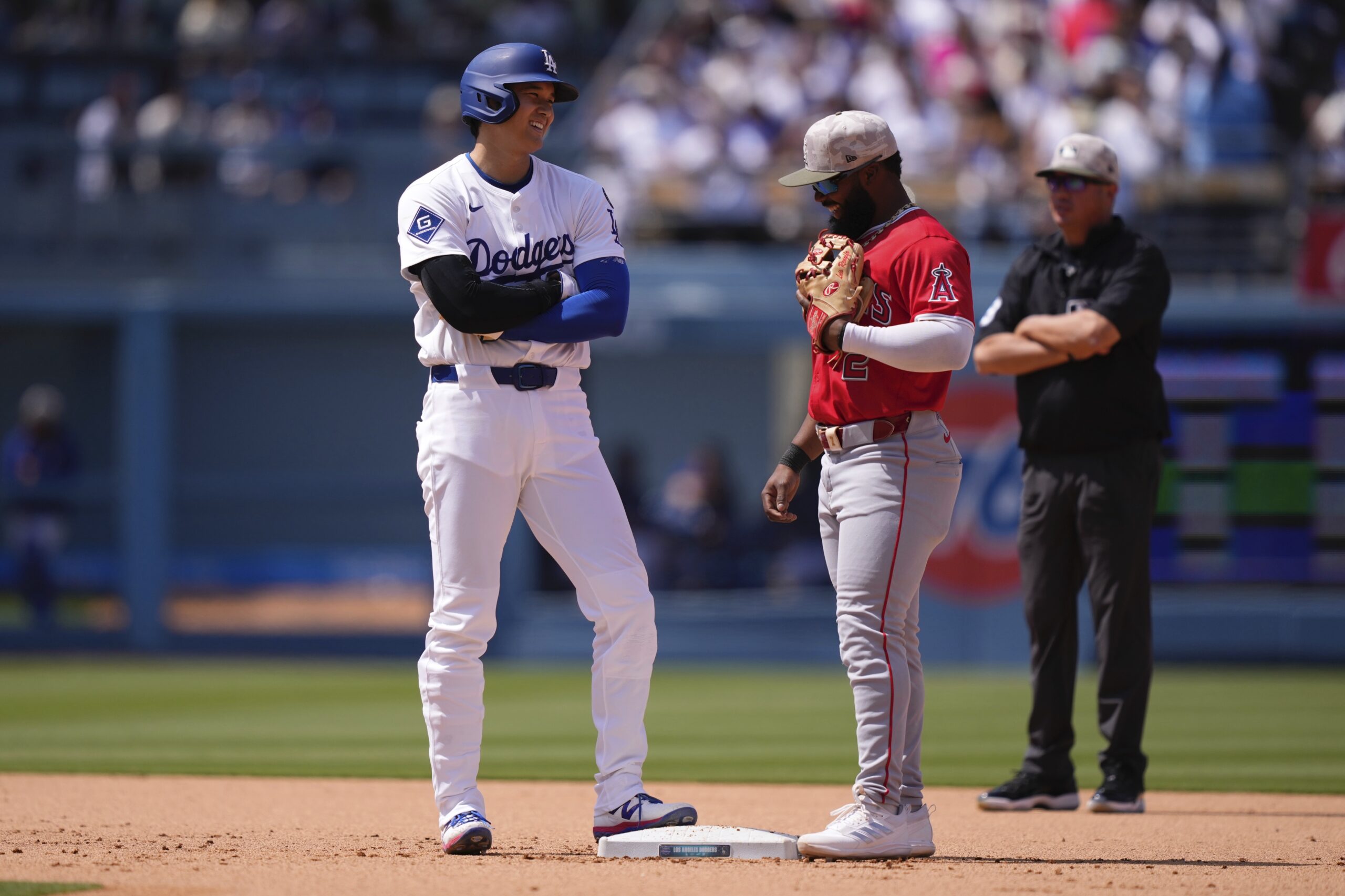 Dodgers’ Shohei Ohtani, left, chats with Angels second baseman Luis...