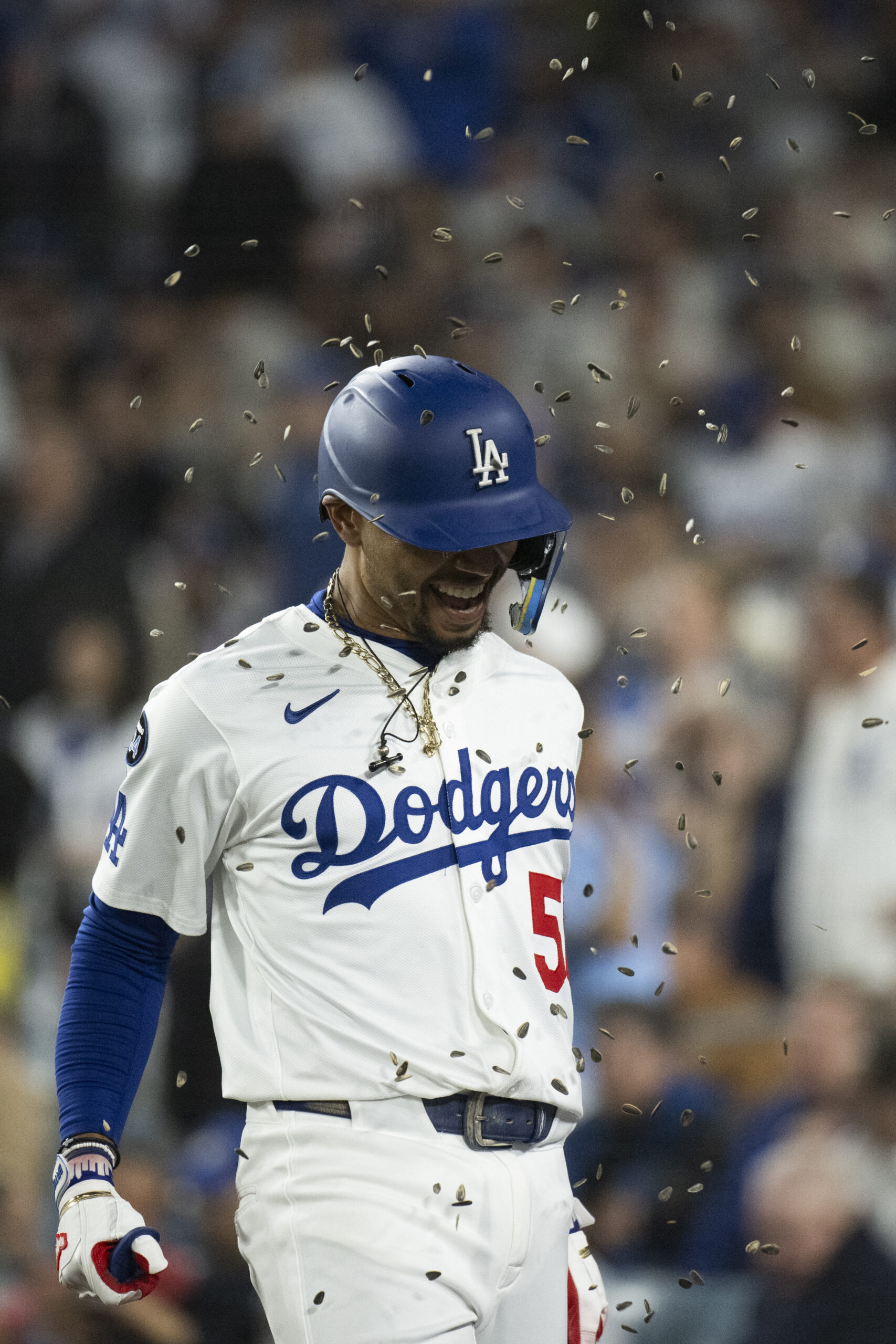 Dodgers’ Mookie Betts gets showered with sunflower seeds after hitting...