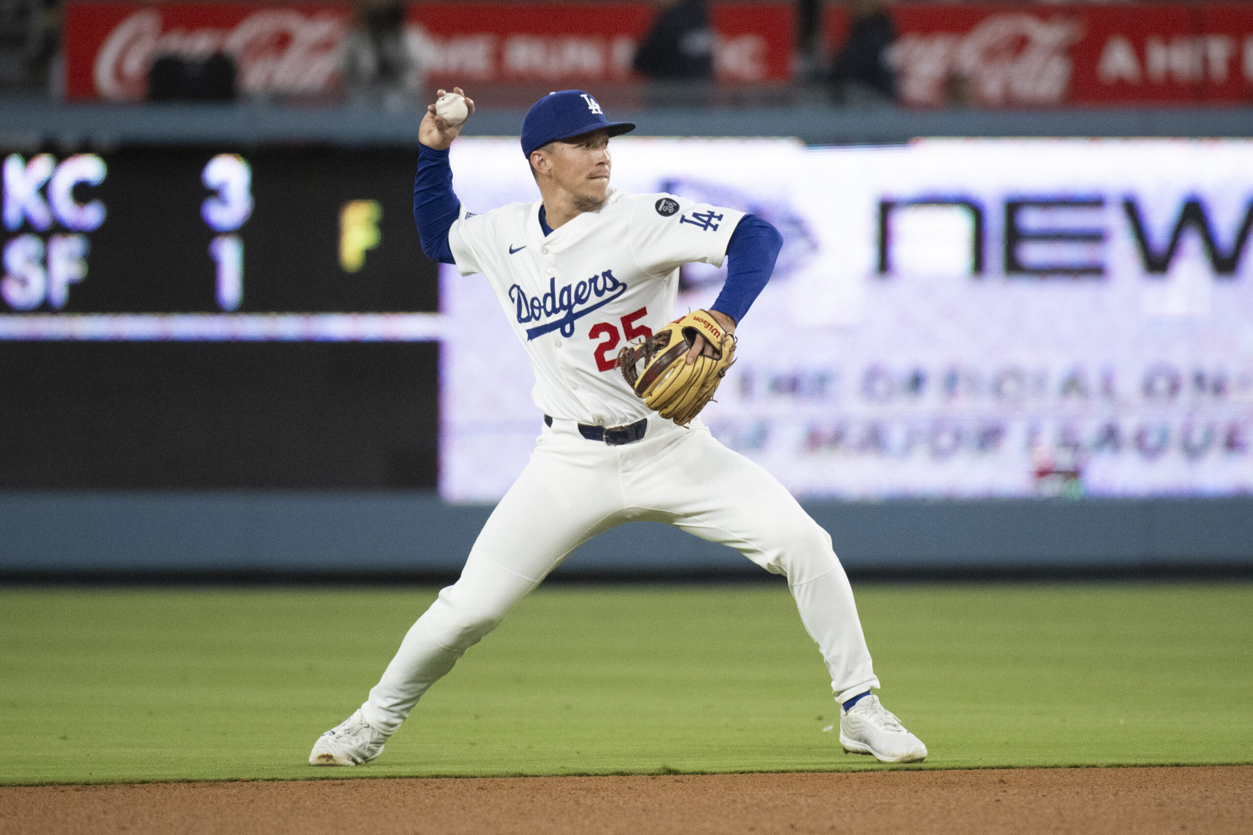 Dodgers second baseman Tommy Edman throws during a baseball game...