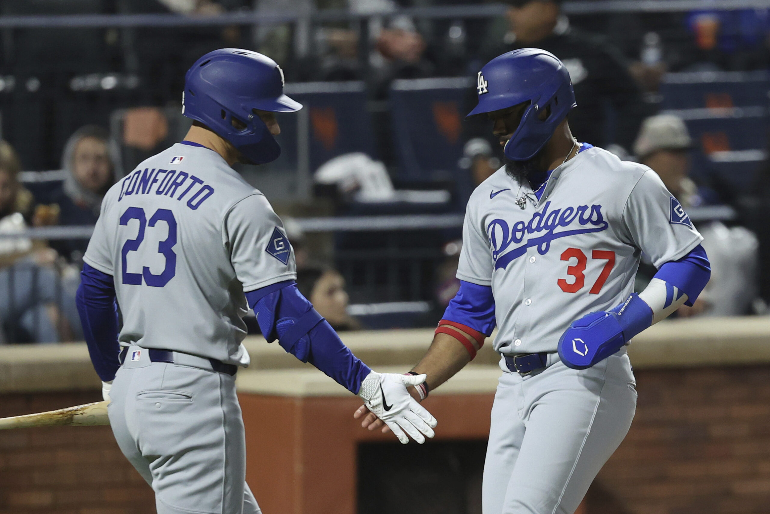 The Dodgers’ Teoscar Hernández, right, celebrates with teammate Michael Conforto...