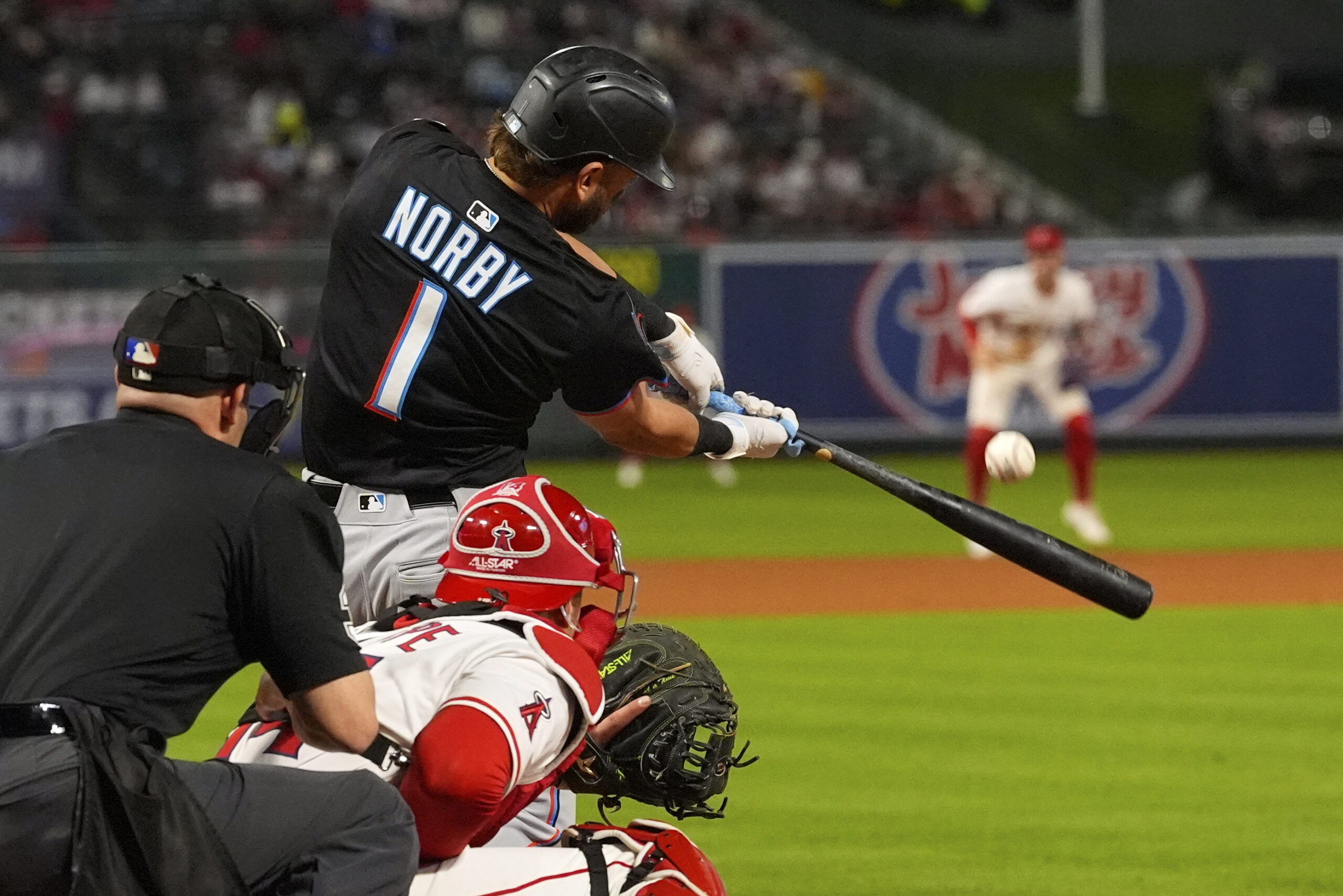 Miami Marlins’ Connor Norby, center, hits a three-run home run...