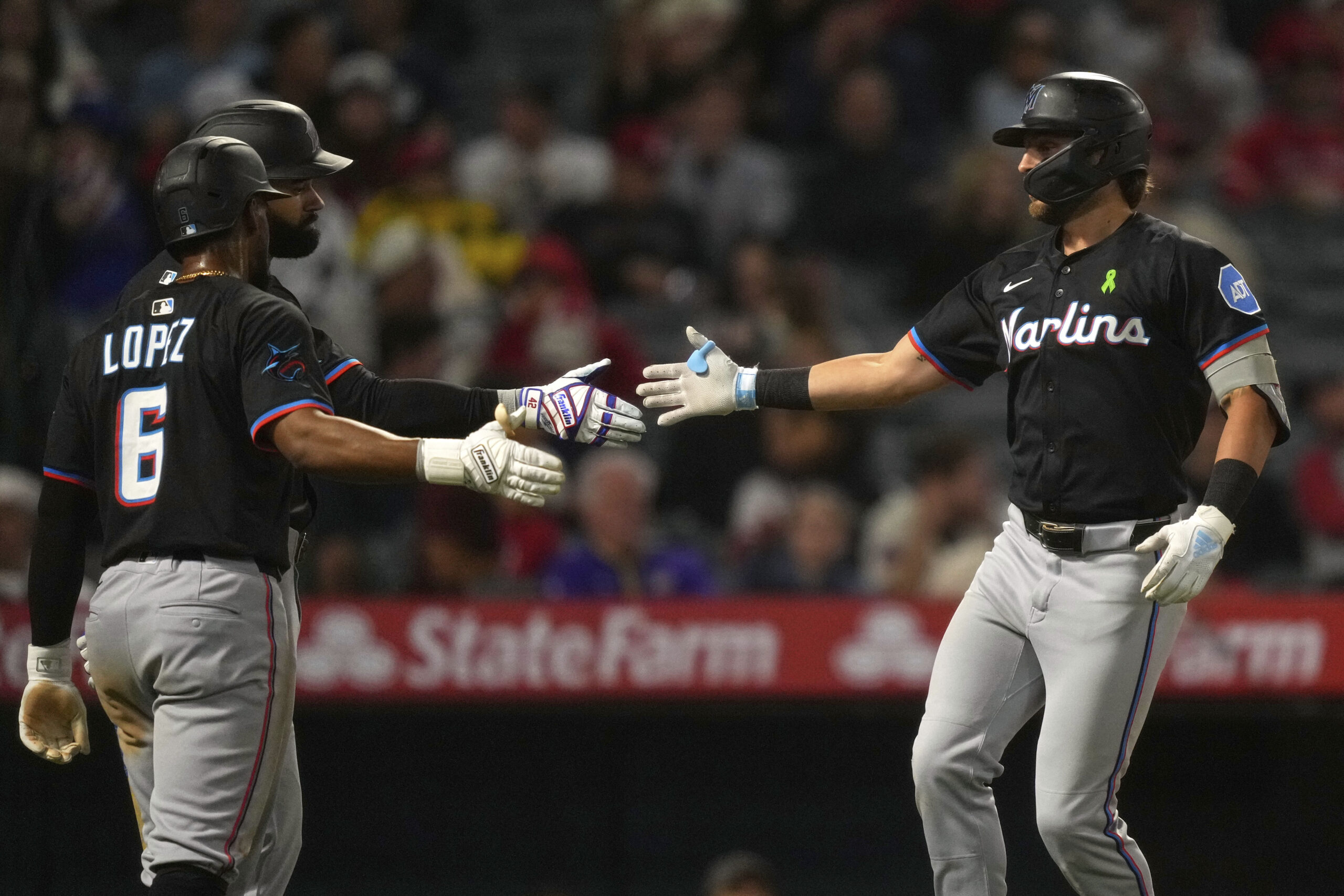 Miami Marlins’ Connor Norby, right, is congratulated by Otto Lopez,...