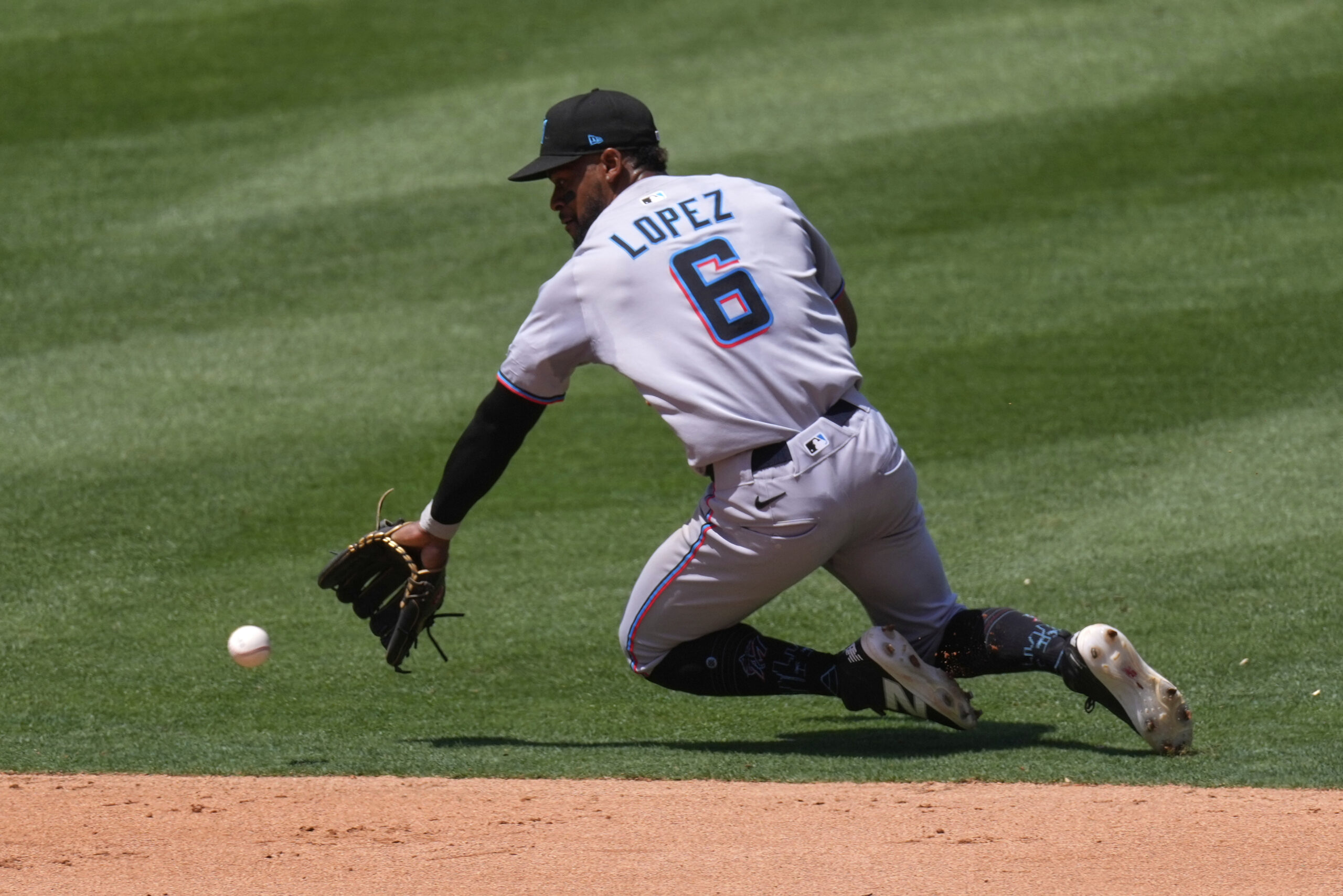 Miami Marlins shortstop Otto Lopez fields a ball hit for...