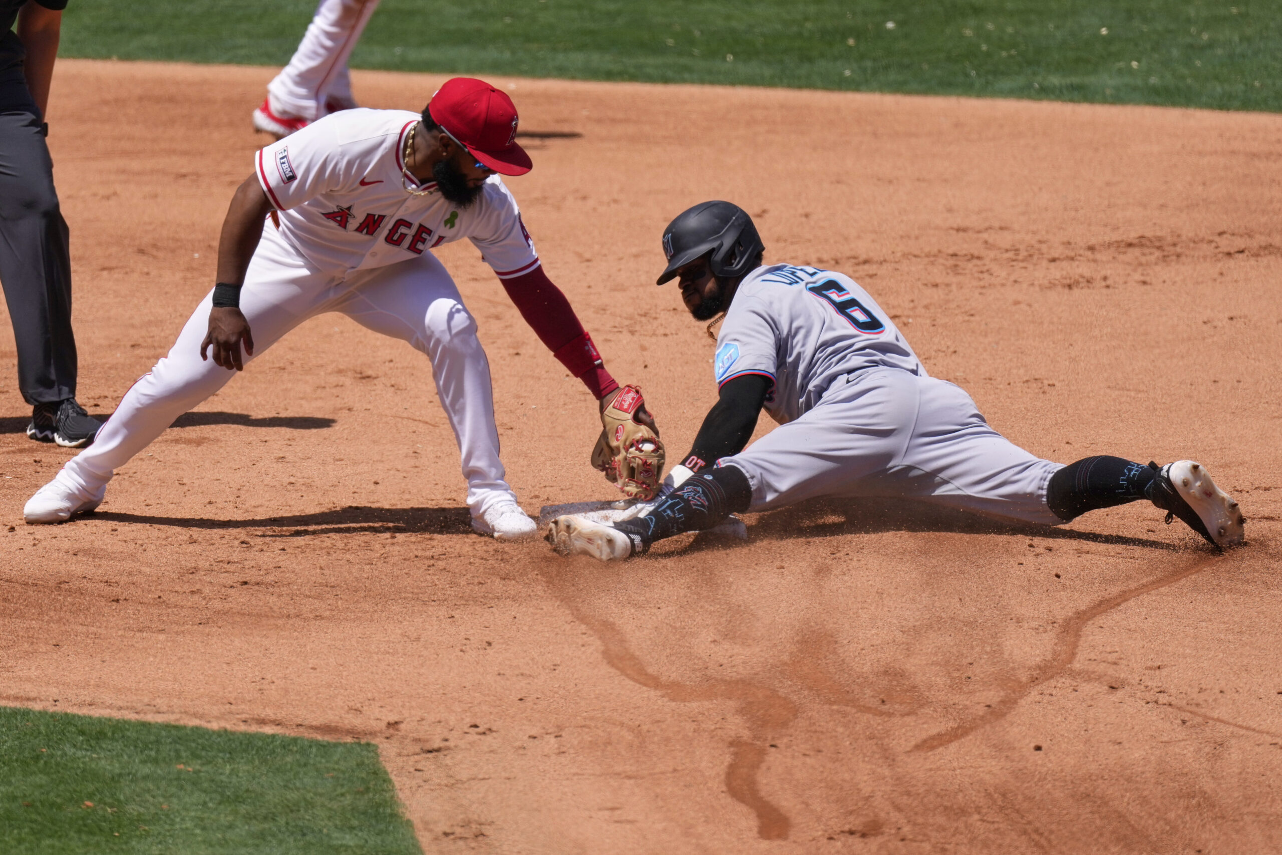 Miami Marlins’ Otto Lopez, right, steals second as Angels second...
