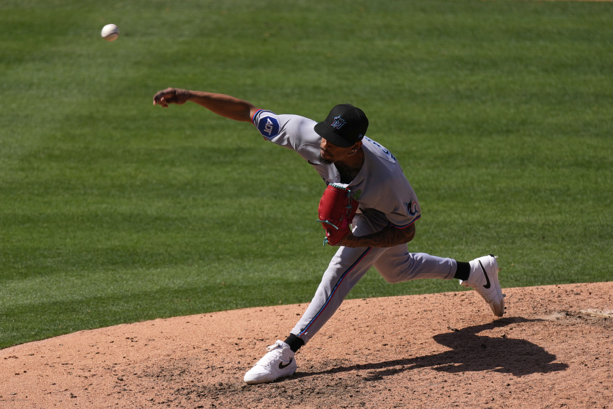Miami Marlins relief pitcher Ronny Henriquez throws to the plate...