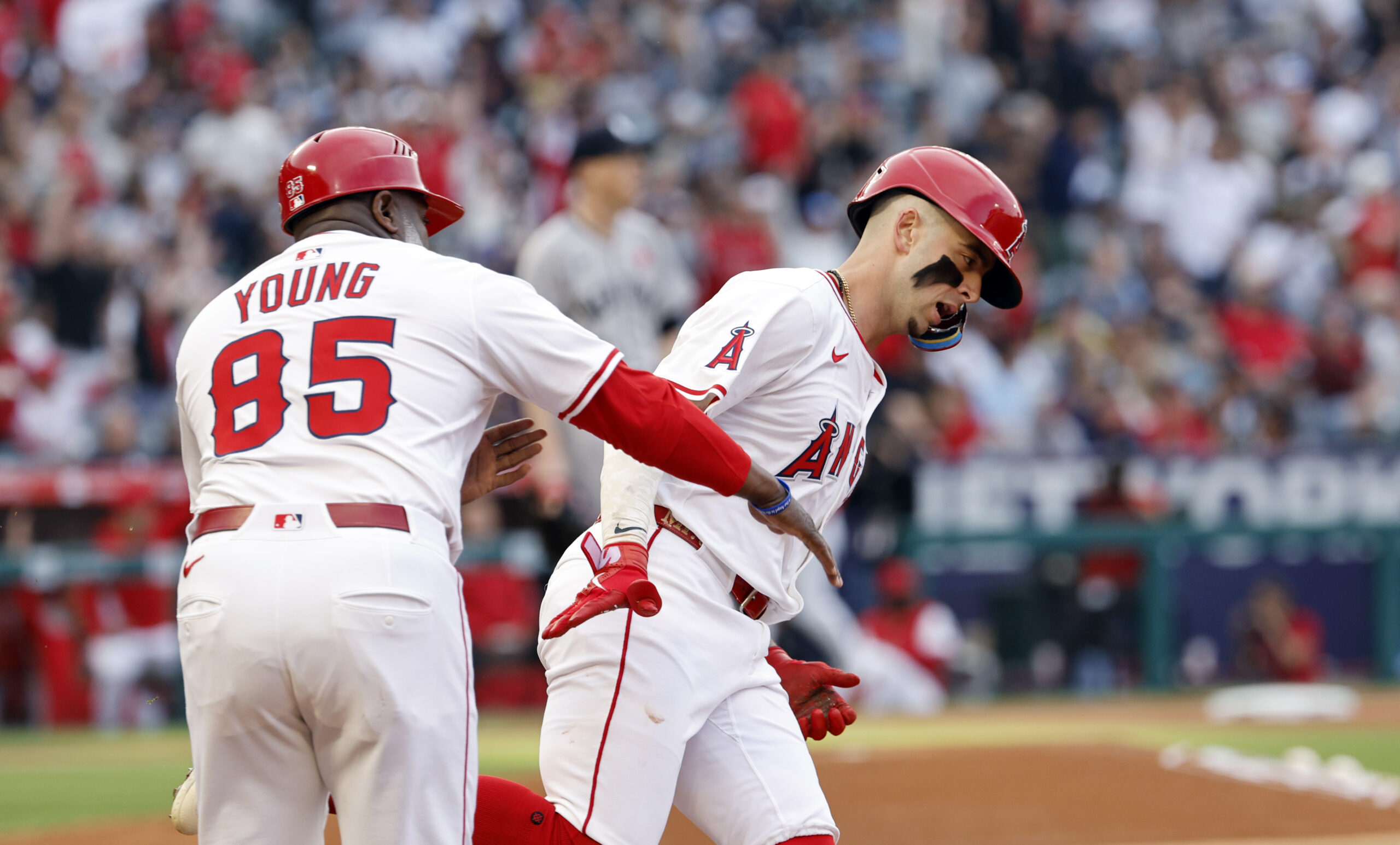 The Angels’ Zach Neto, right, is congratulated by first base...