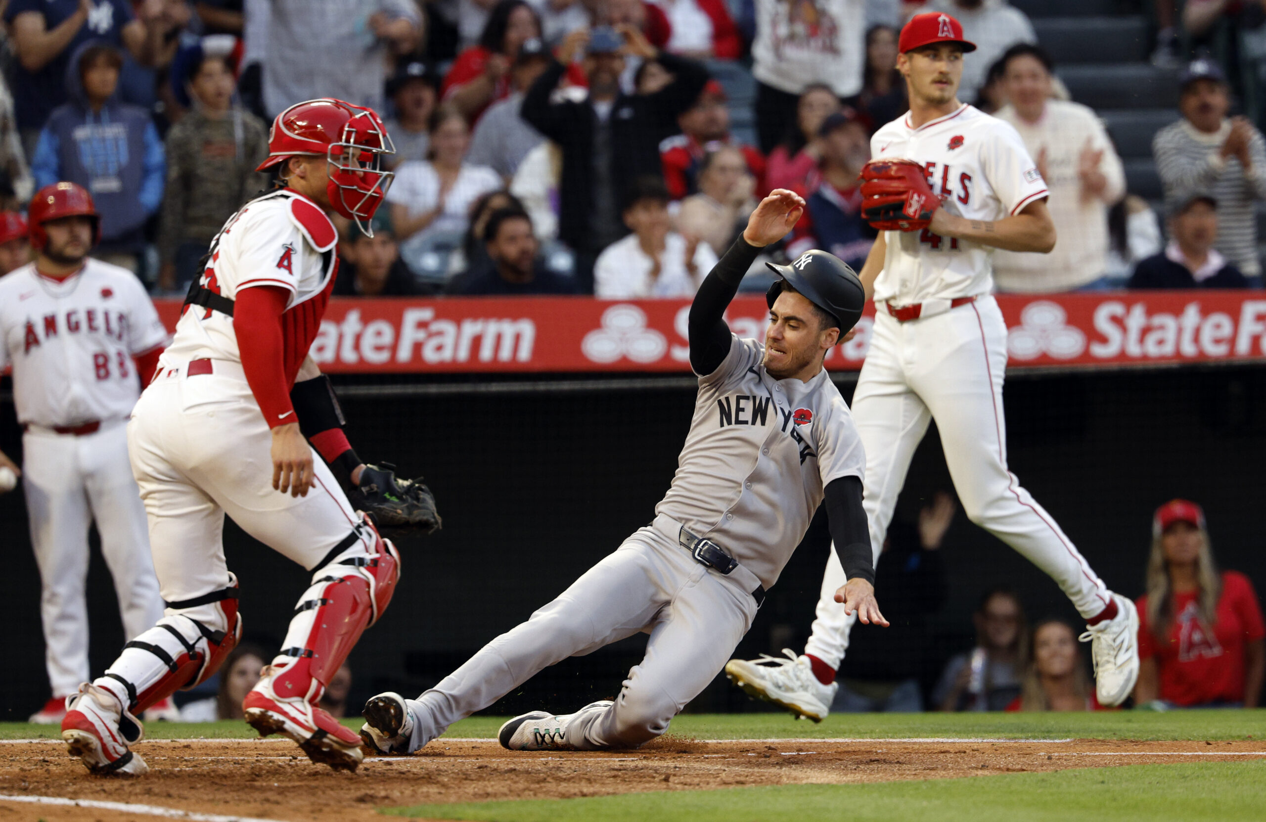 The New York Yankees’ Cody Bellinger slides home to score...
