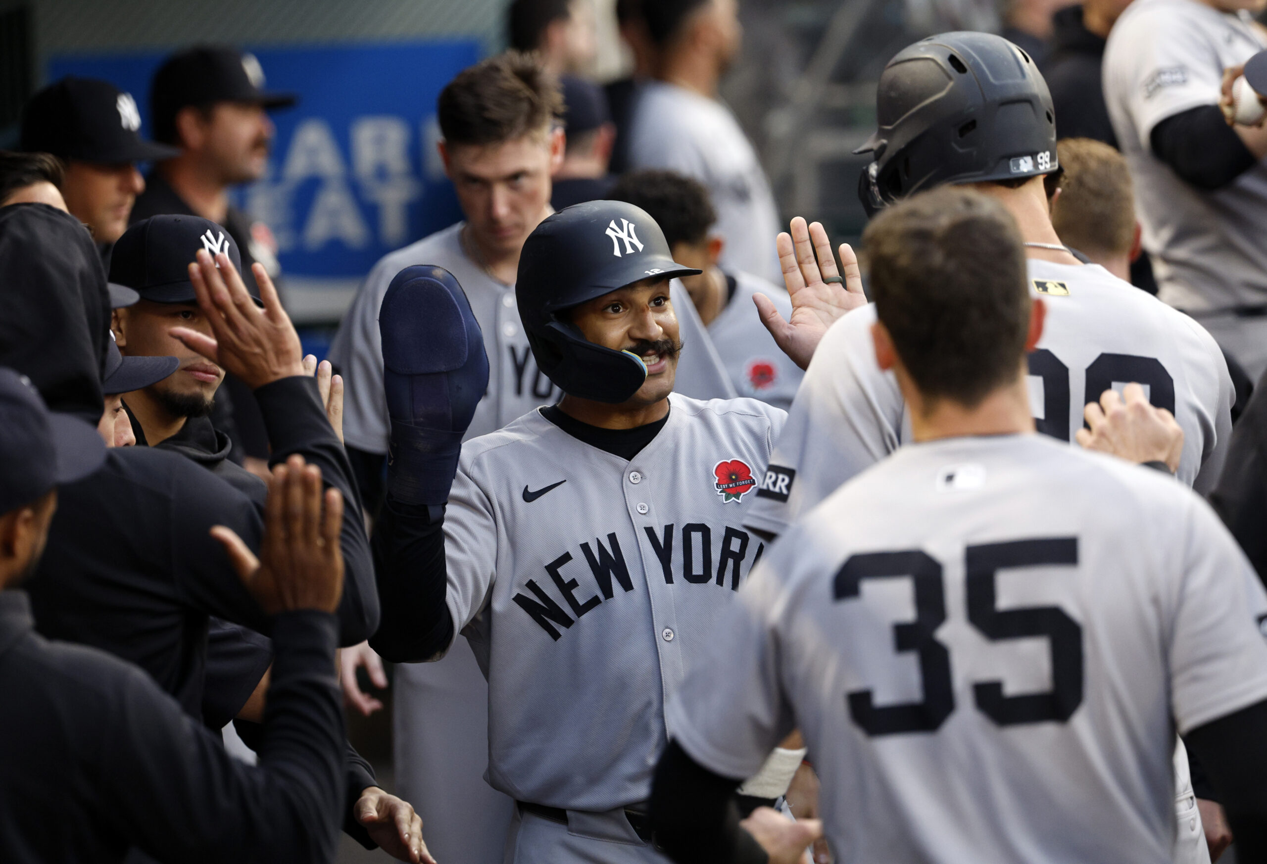 The New York Yankees’ Trent Grisham, center, is congratulated in...