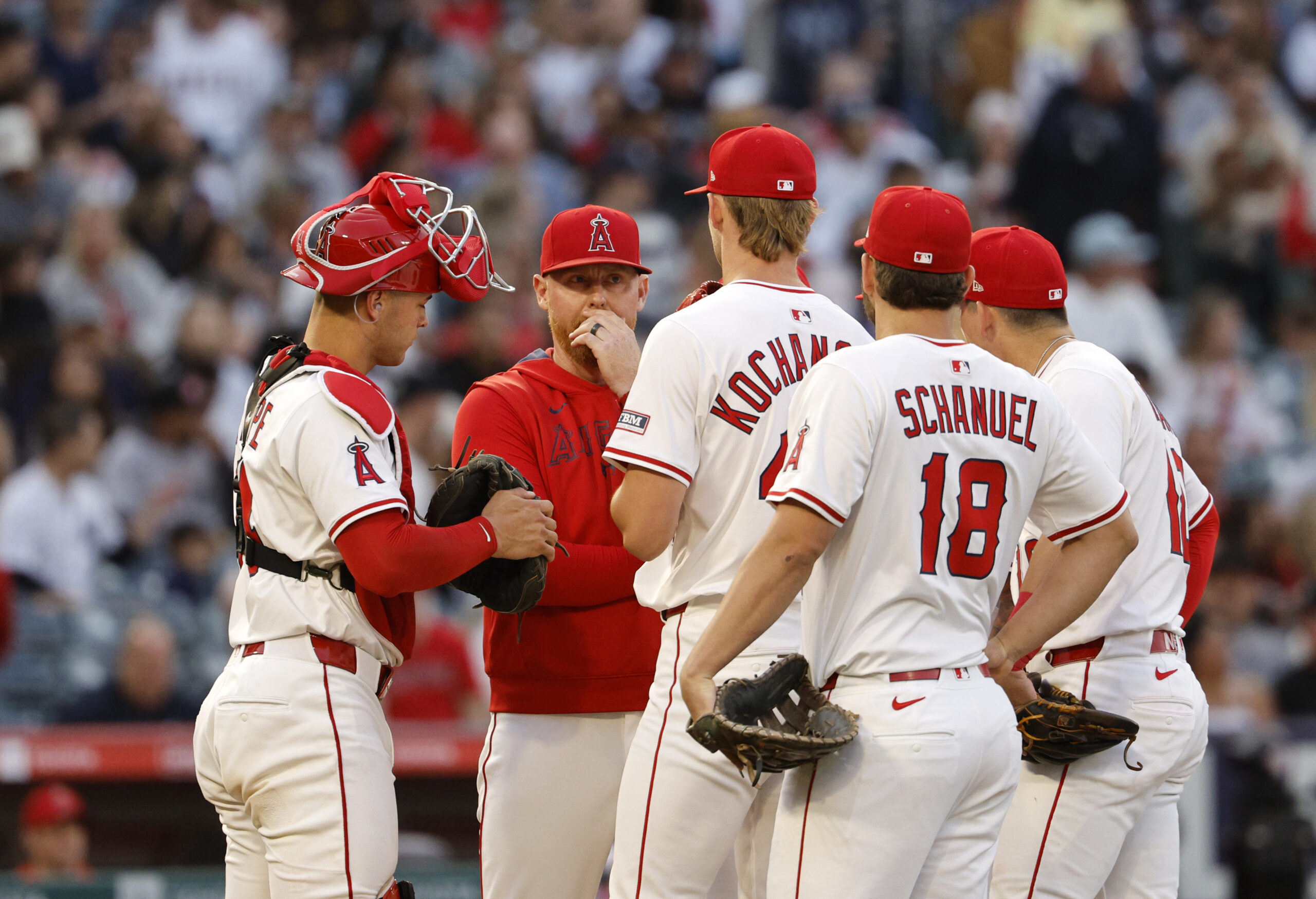 Angels pitching coach Barry Enright, second left, talks with starting...