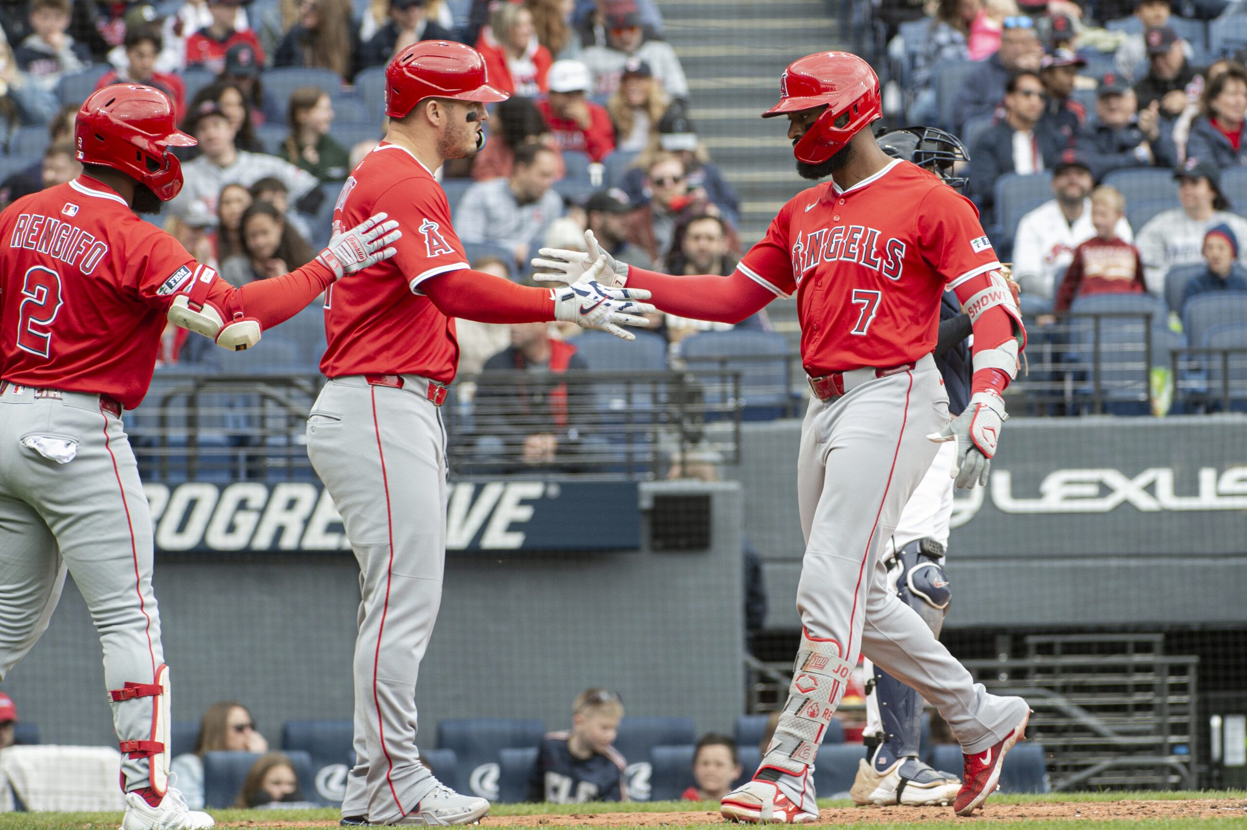 Angels’ Jo Adell (7) is congratulated by Luis Rengifo (2)...