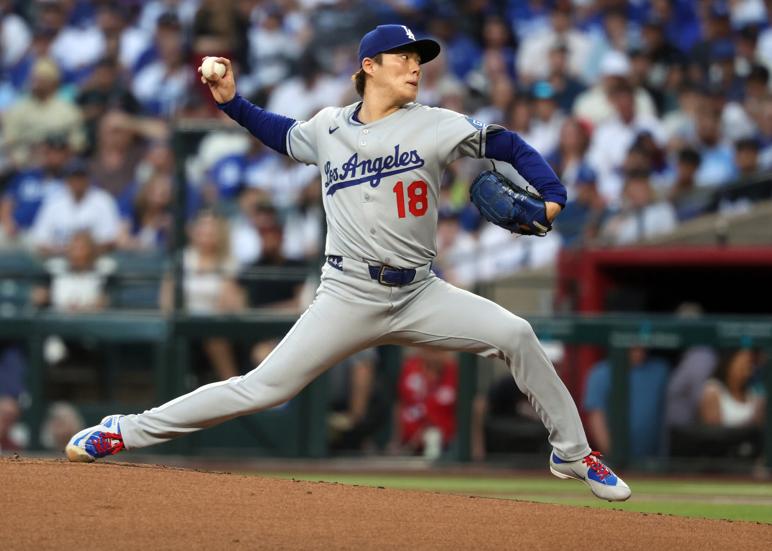 Dodgers starting pitcher Yoshinobu Yamamoto throws to the plate during...