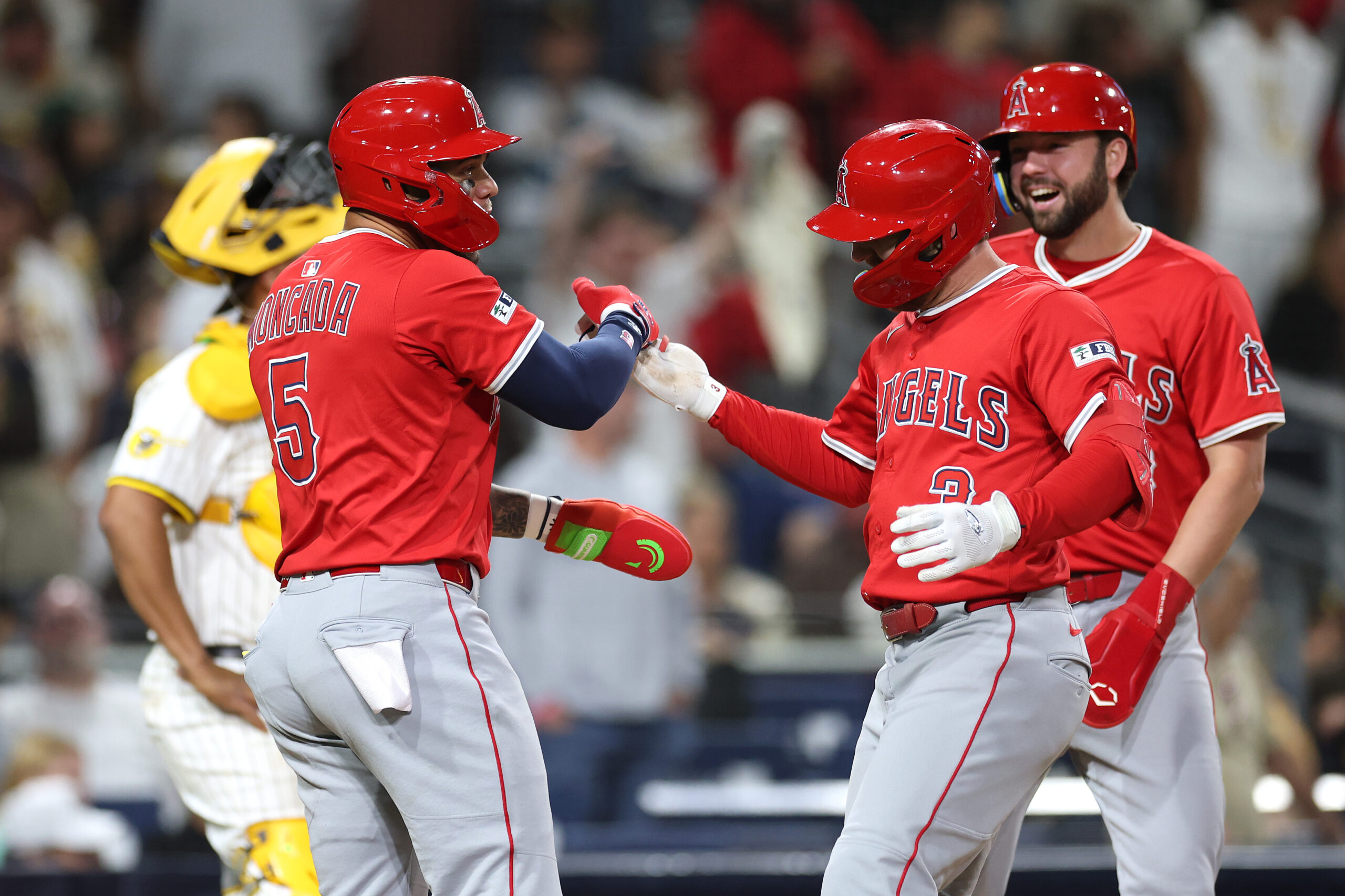 The Angels’ Yoán Moncada, left, and Nolan Schanuel, far right,...