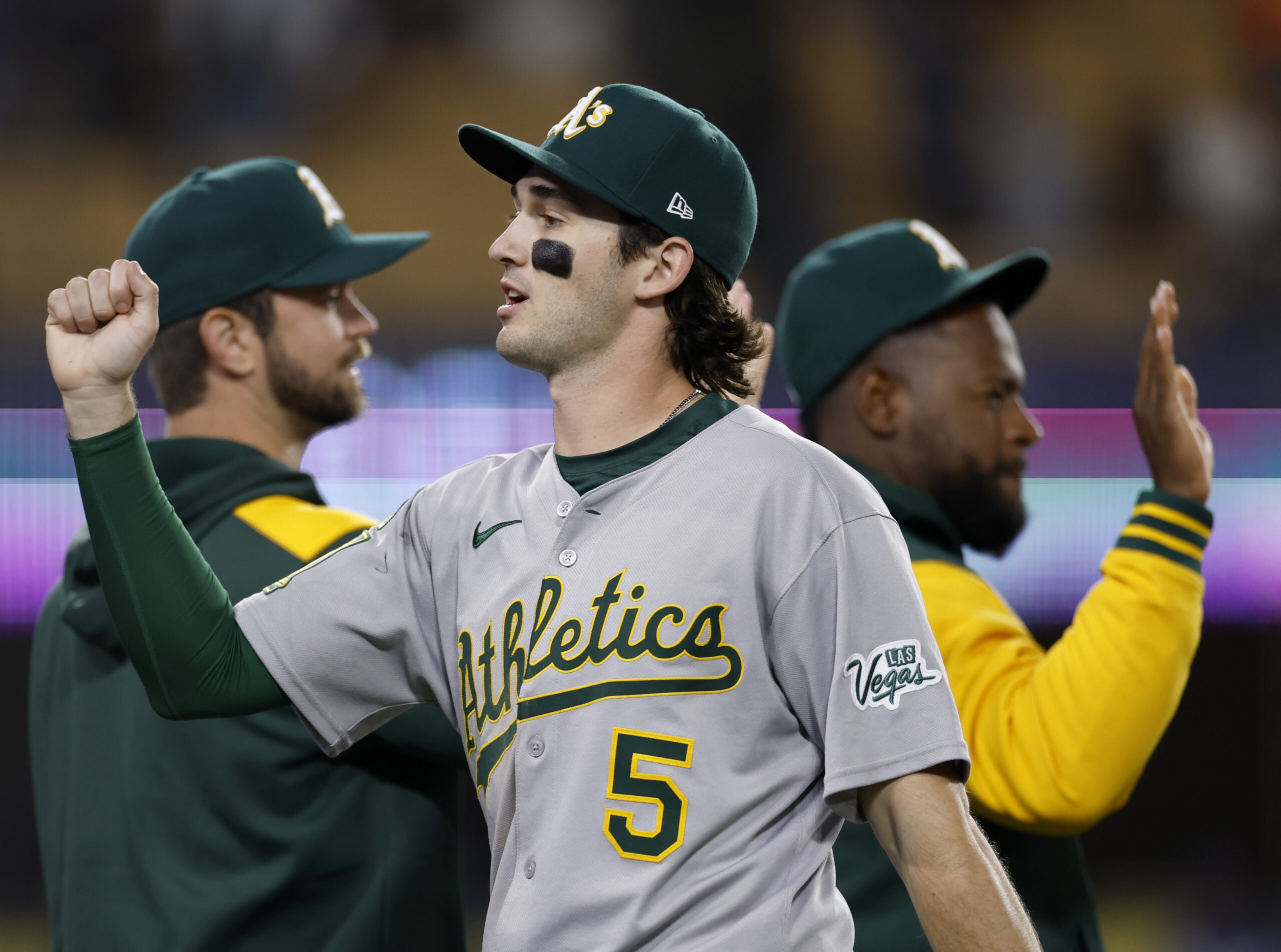 Athletics shortstop Jacob Wilson celebrates with teammates after their 11-1...