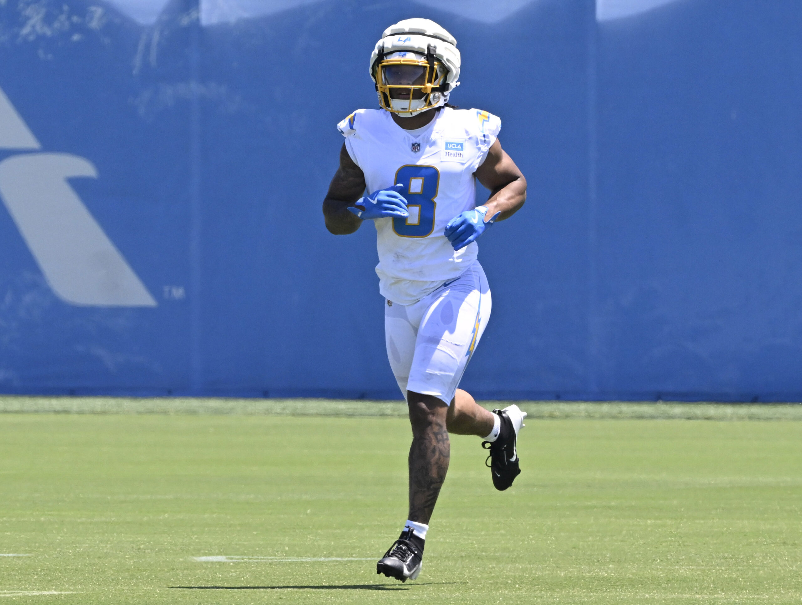 Chargers running back Omarion Hampton jogs on the field during...