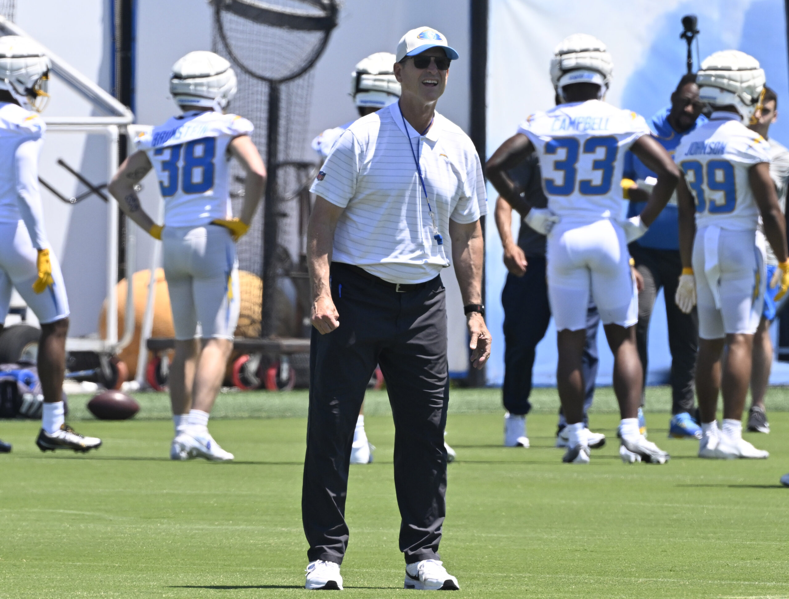 Chargers head coach looks on as players go through drills...