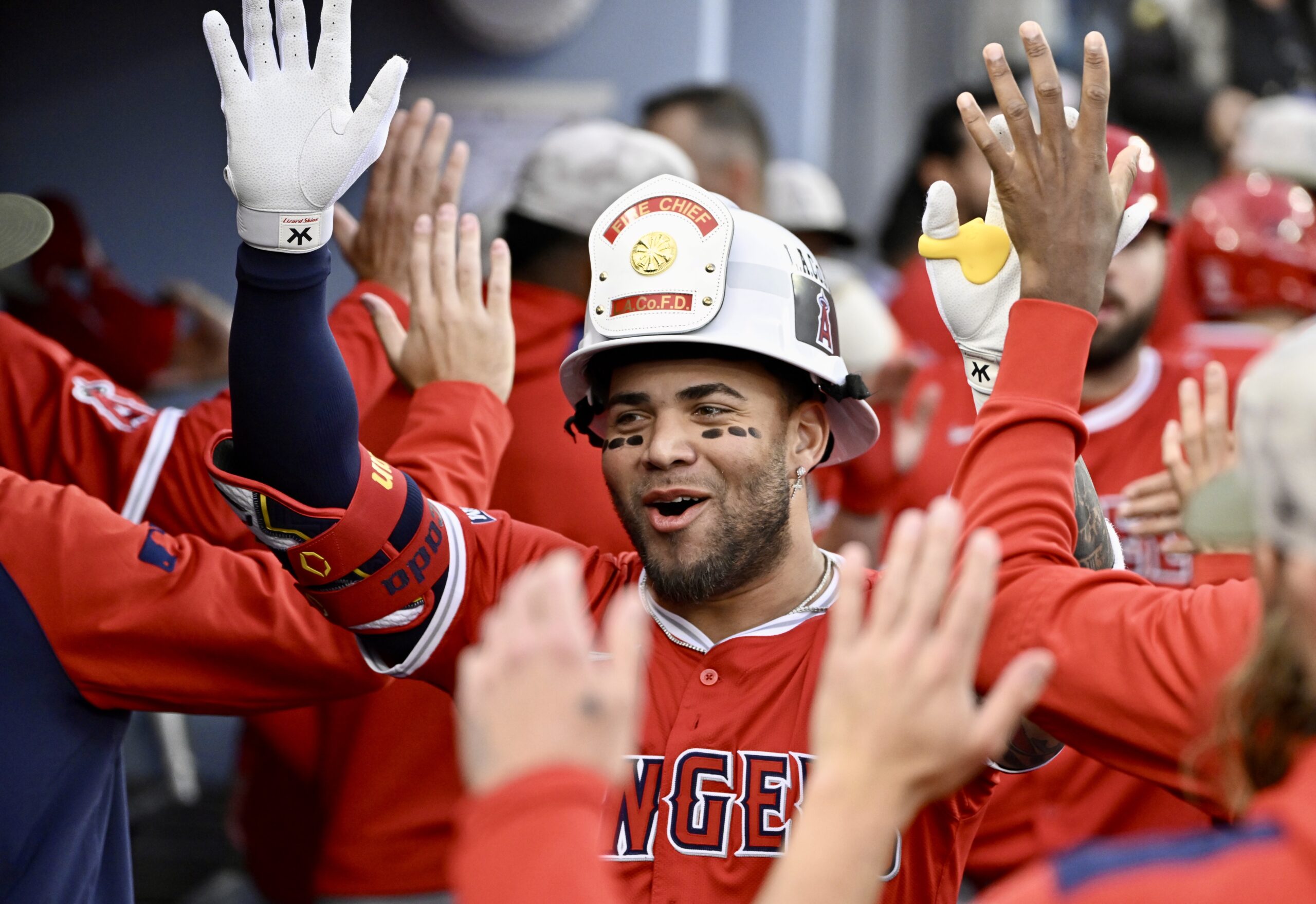 Yoan Moncada #5 of the Los Angeles Angels high fives...