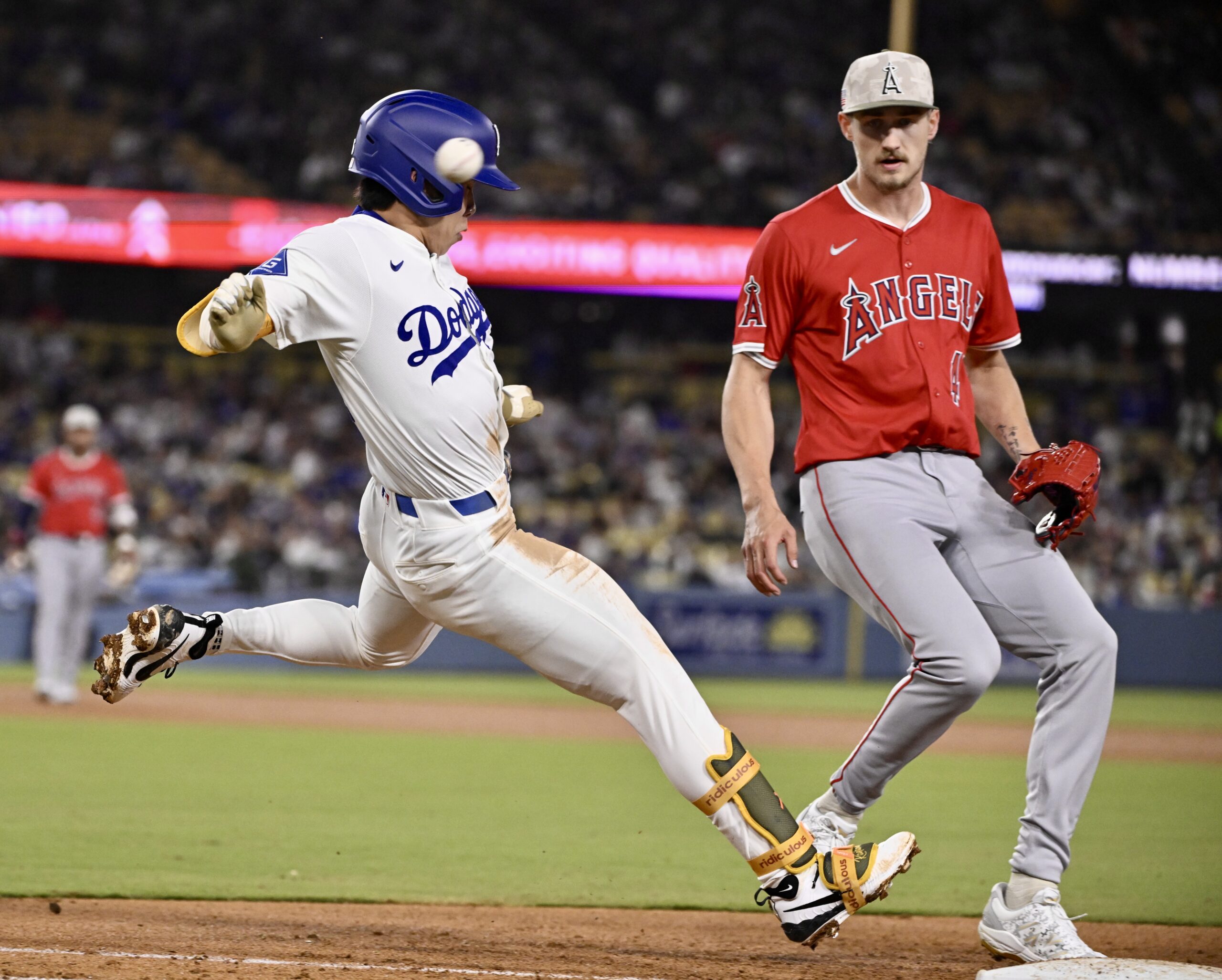 Hyeseong Kim #6 of the Los Angeles Dodgers singles as...