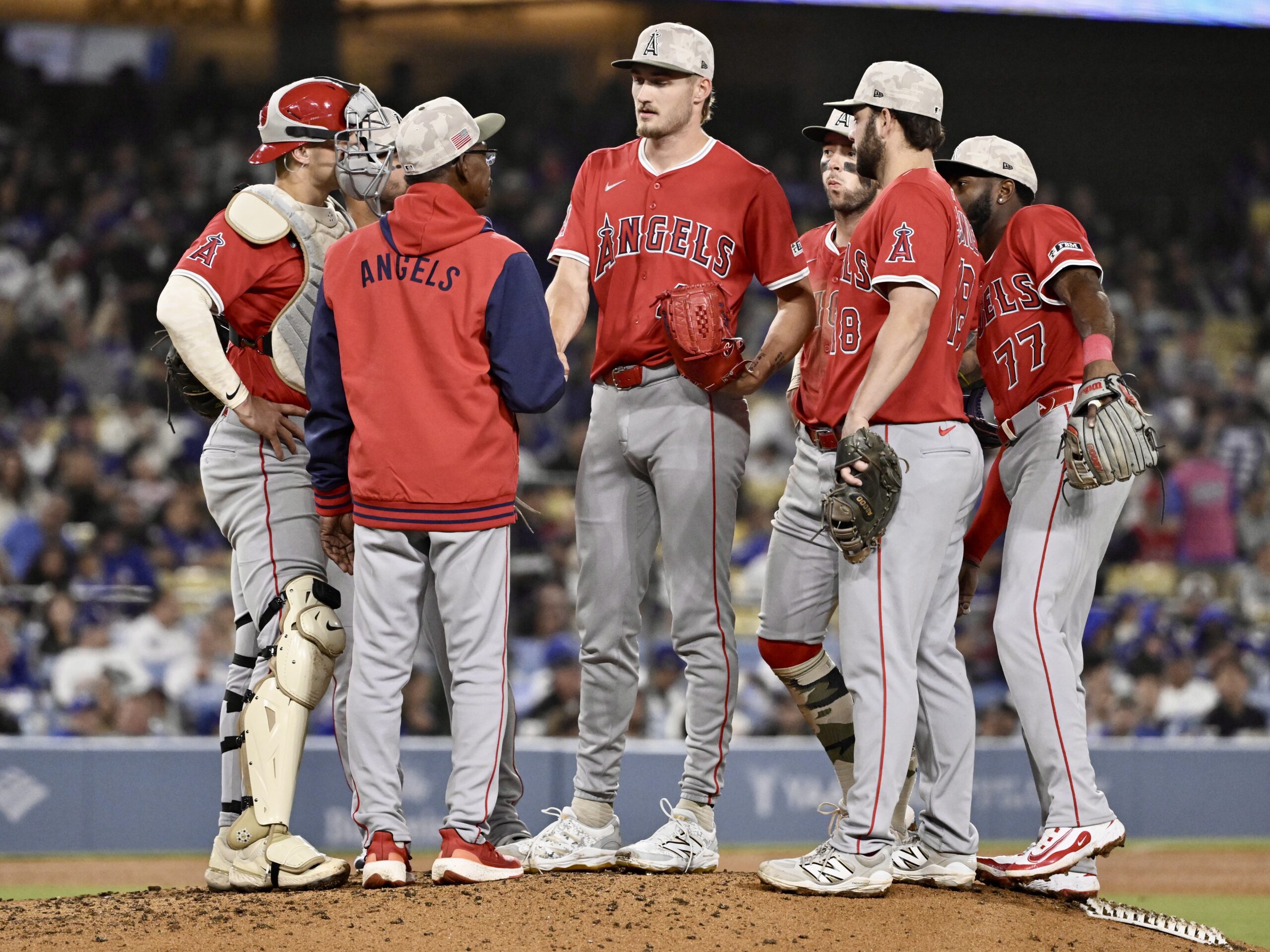 Manager Ron Washington #37 shakes hands with starting pitcher Jack...