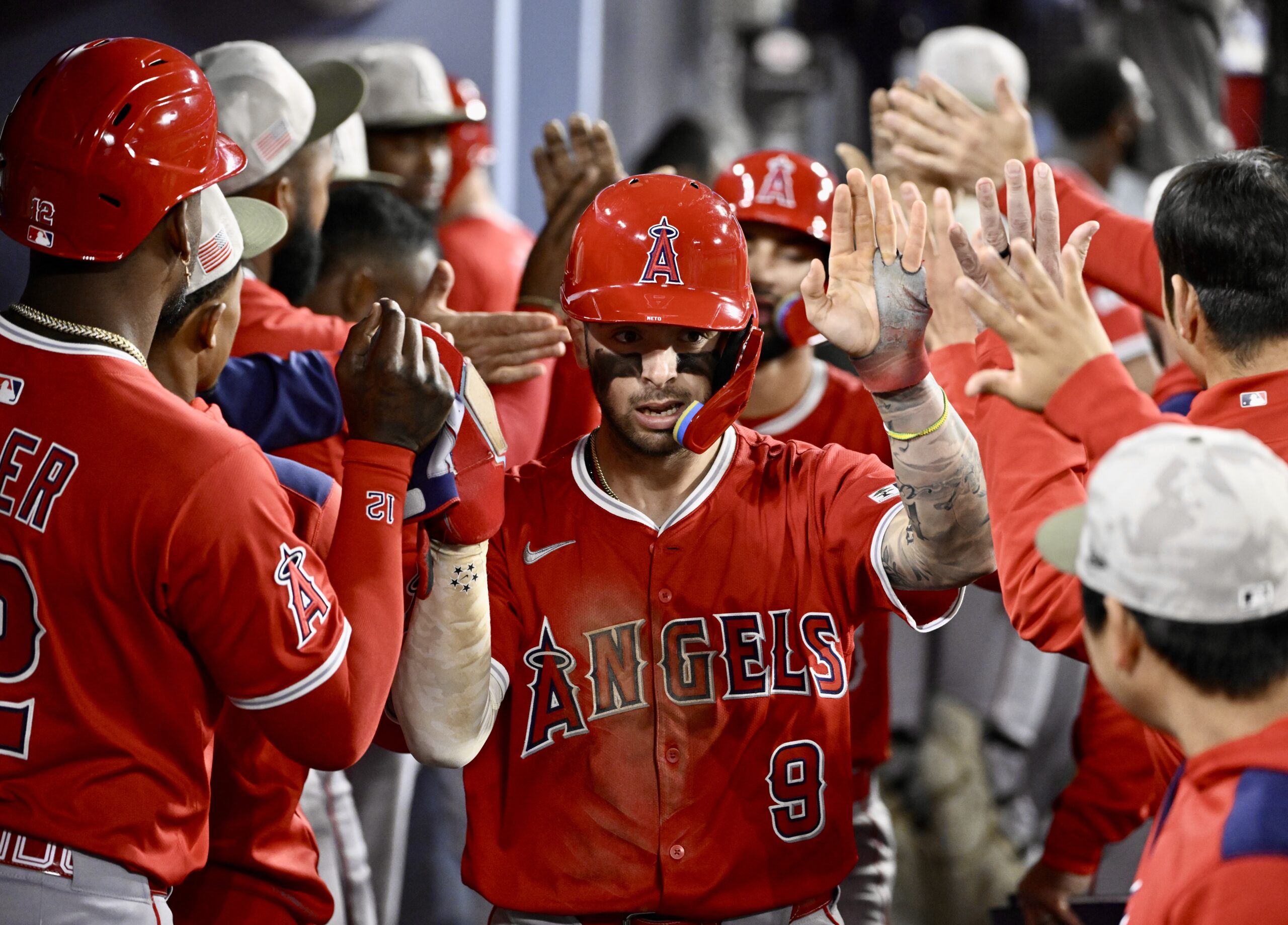 Zach Neto #9 of the Los Angeles Angels high fives...
