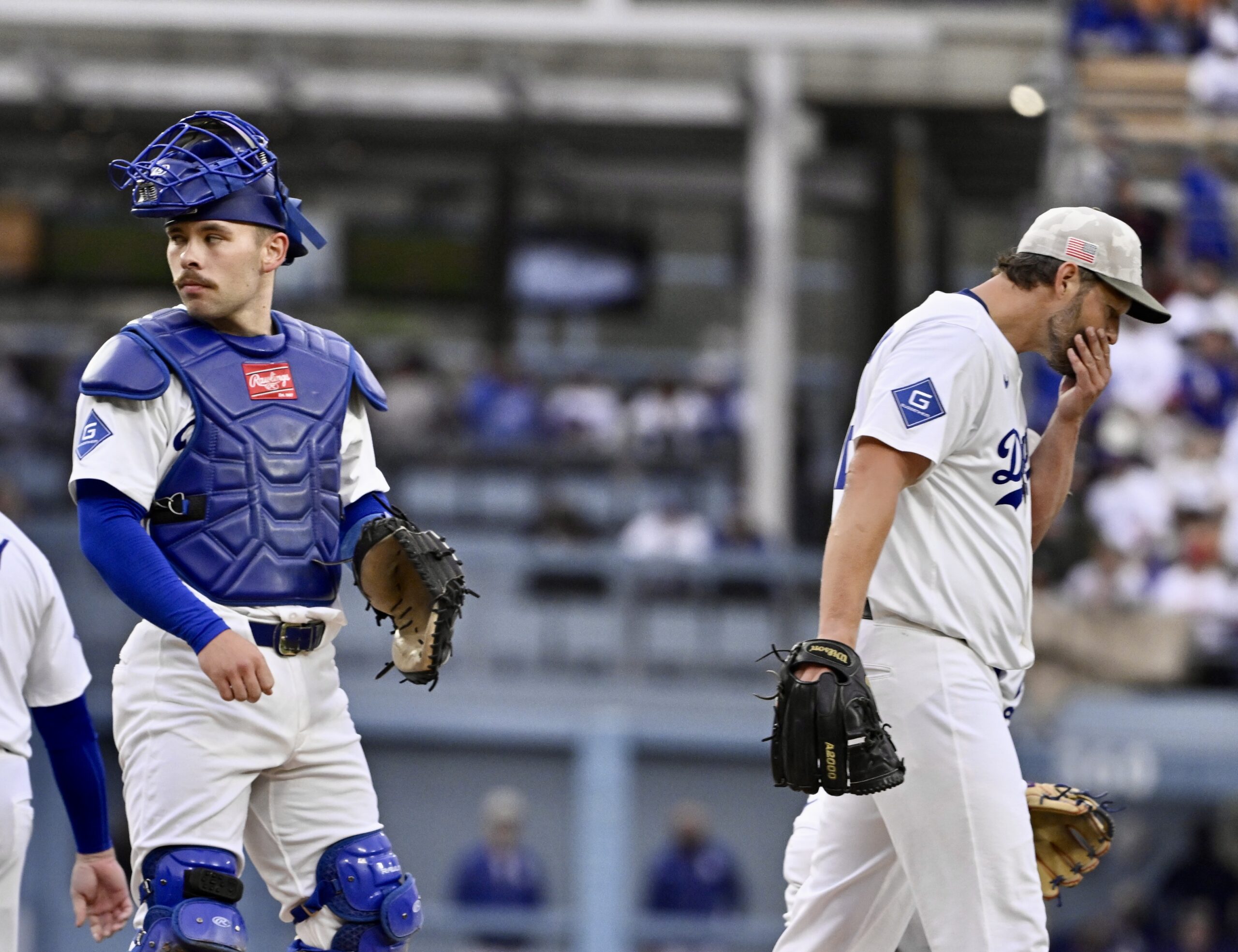 Starting pitcher Clayton Kershaw #22 of the Dodgers wipes his...