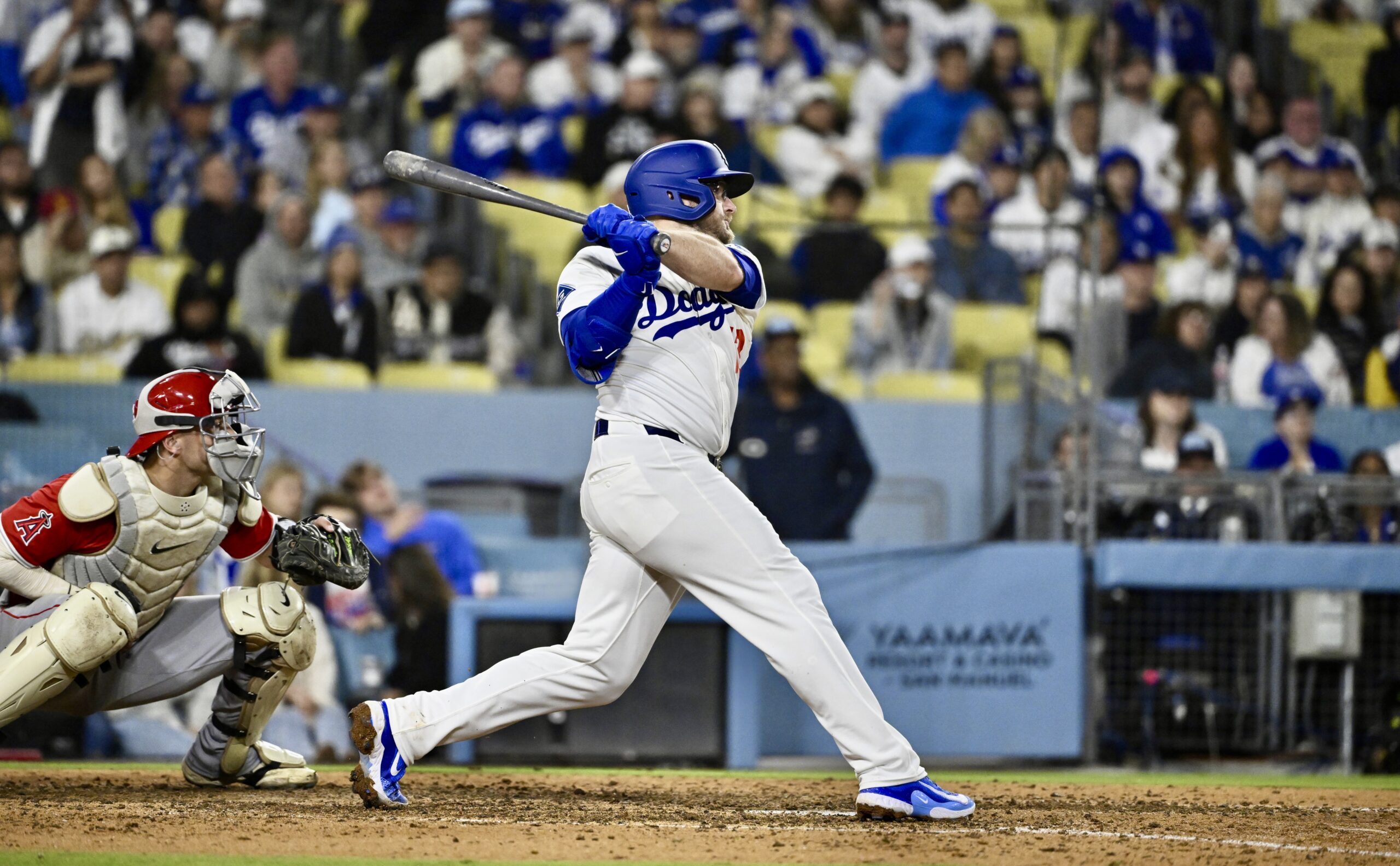Max Muncy #13 of the Dodgers hits a RBI single...