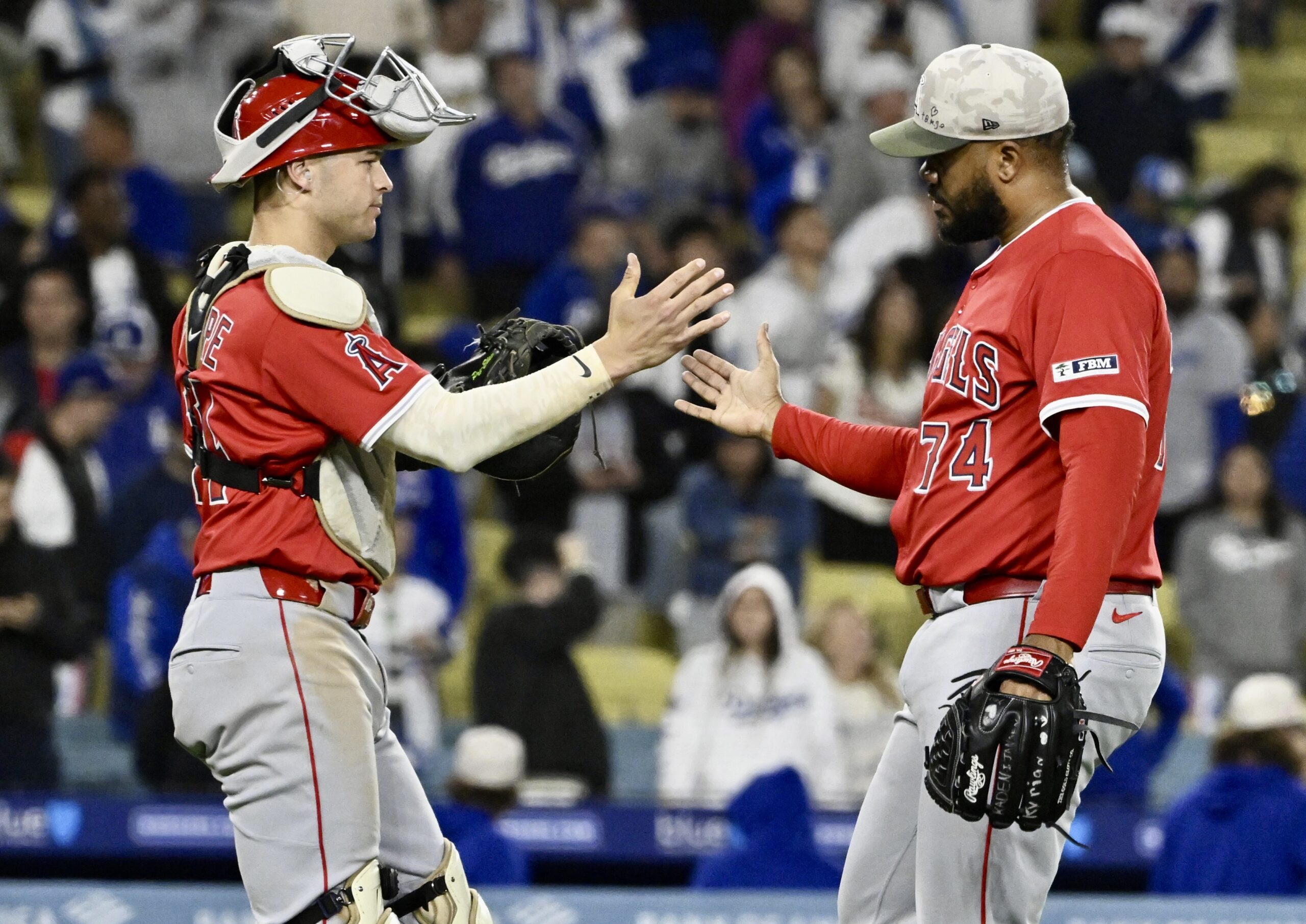 Relief pitcher Kenley Jansen #74 of the Angels shakes hands...