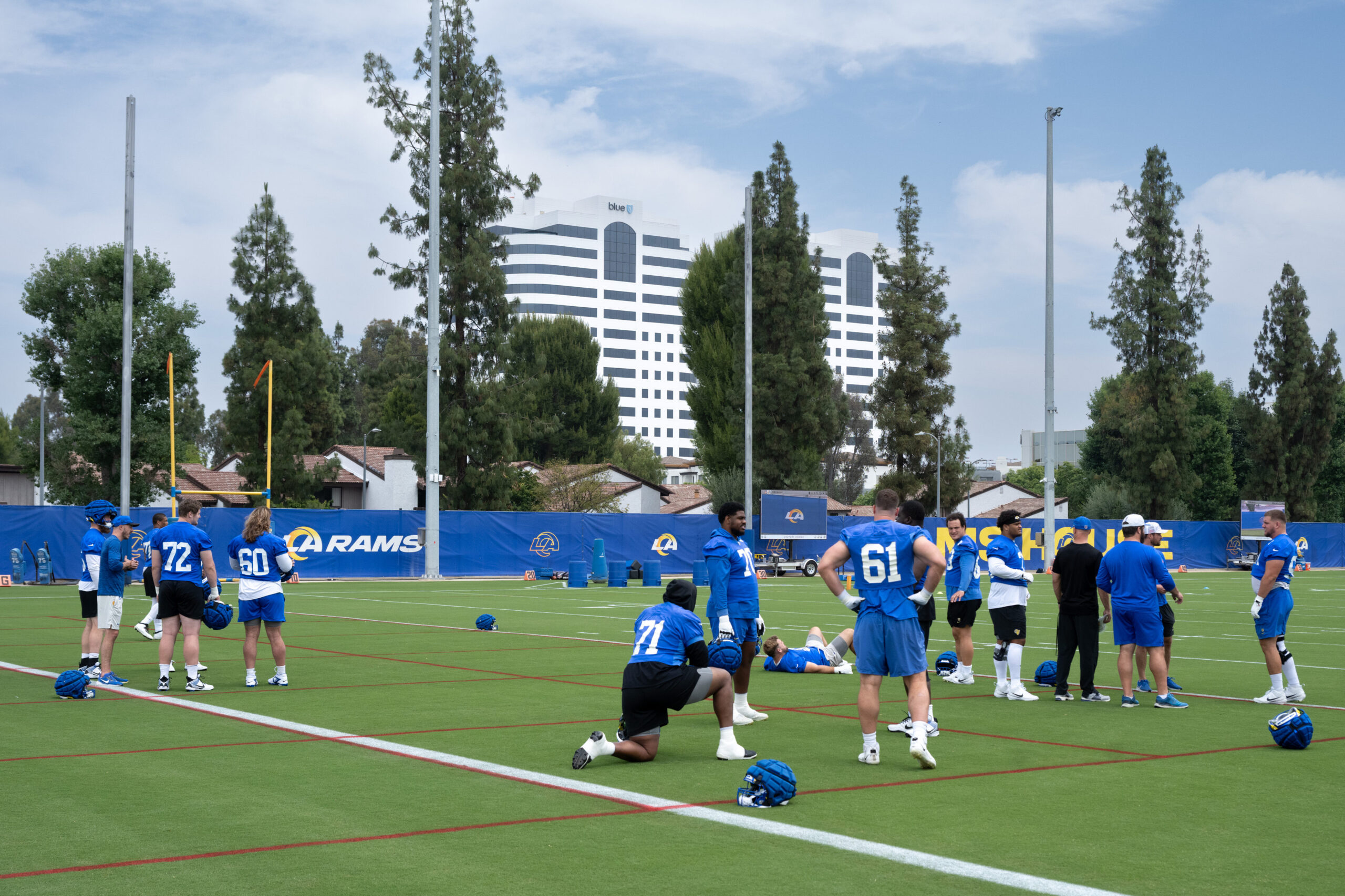 Rams players take the field during an OTA workout on...