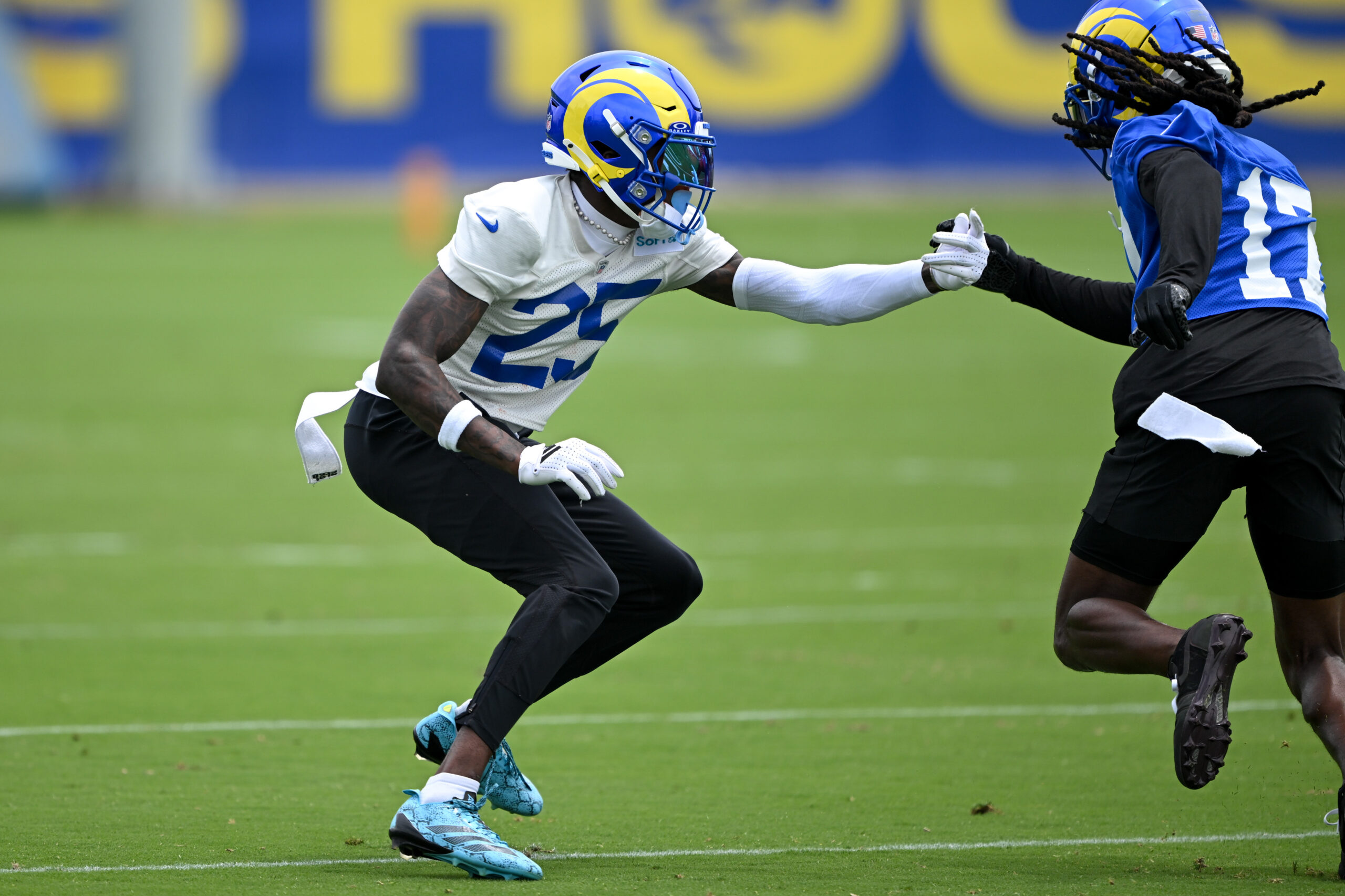 Rams cornerback Emmanuel Forbes, left, and wide receiver Davante Adams...