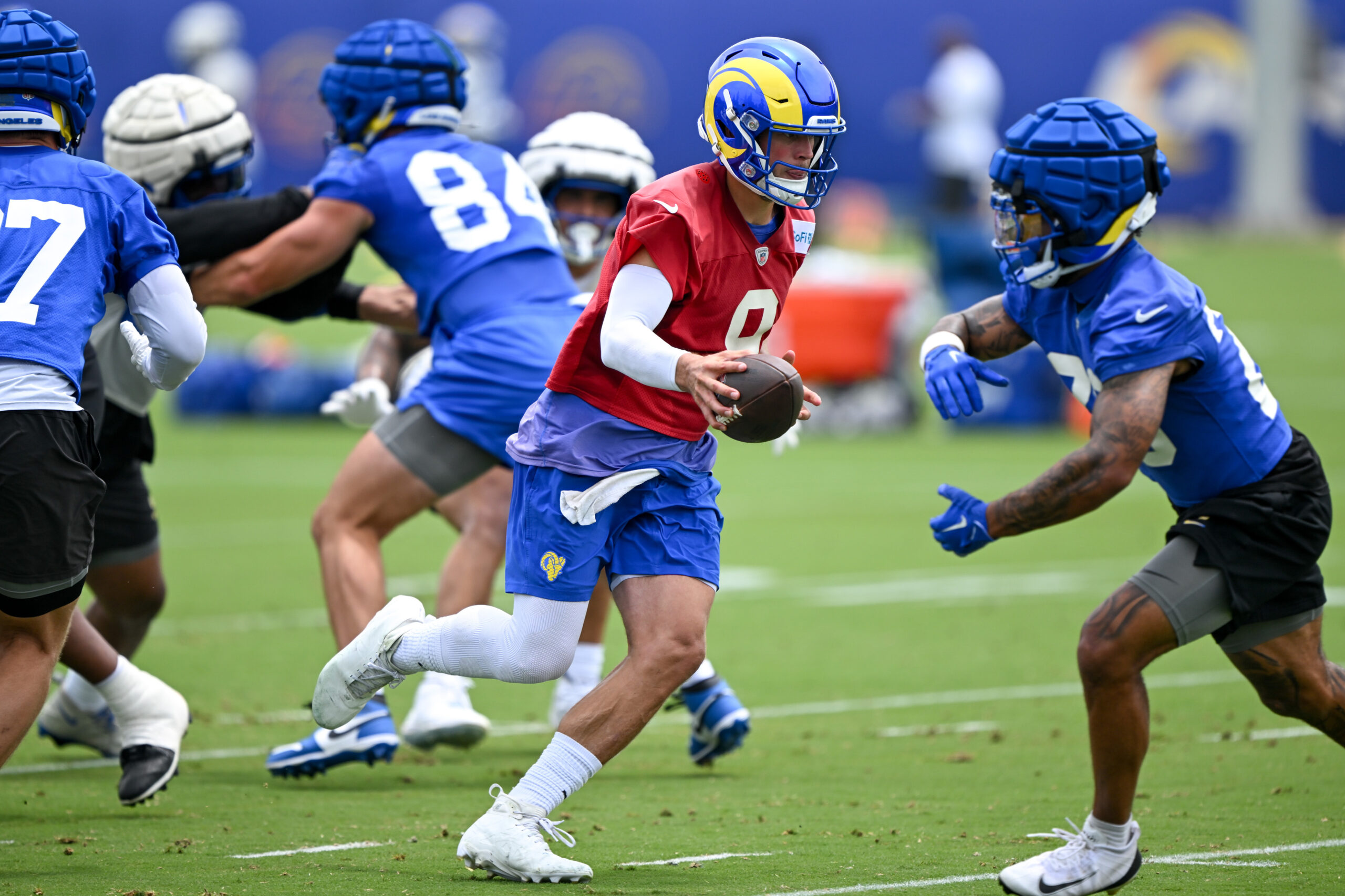 Rams quarterback Matthew Stafford hands the ball off to running...
