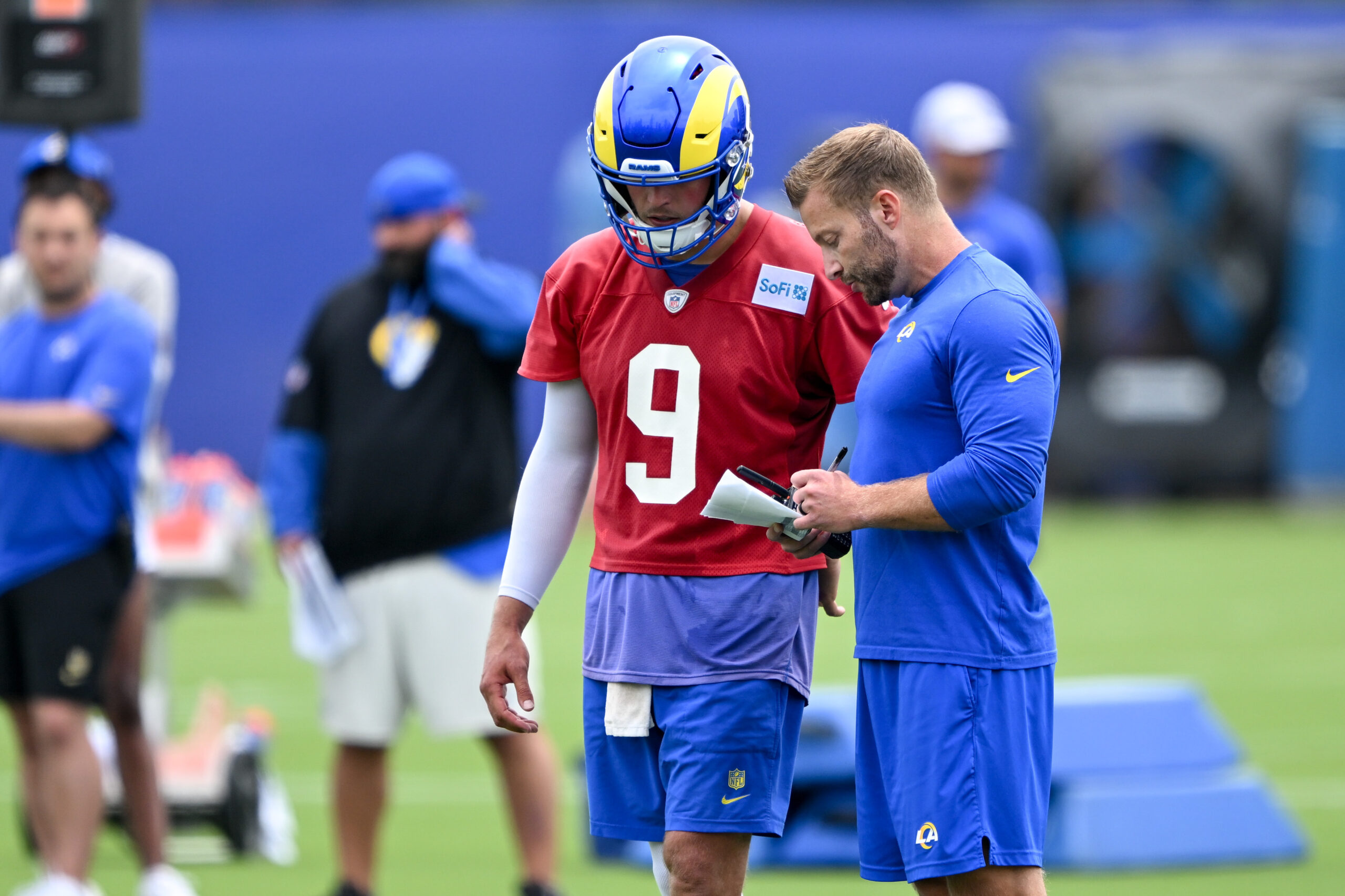 Rams quarterback Matthew Stafford talks to head coach Sean McVay...