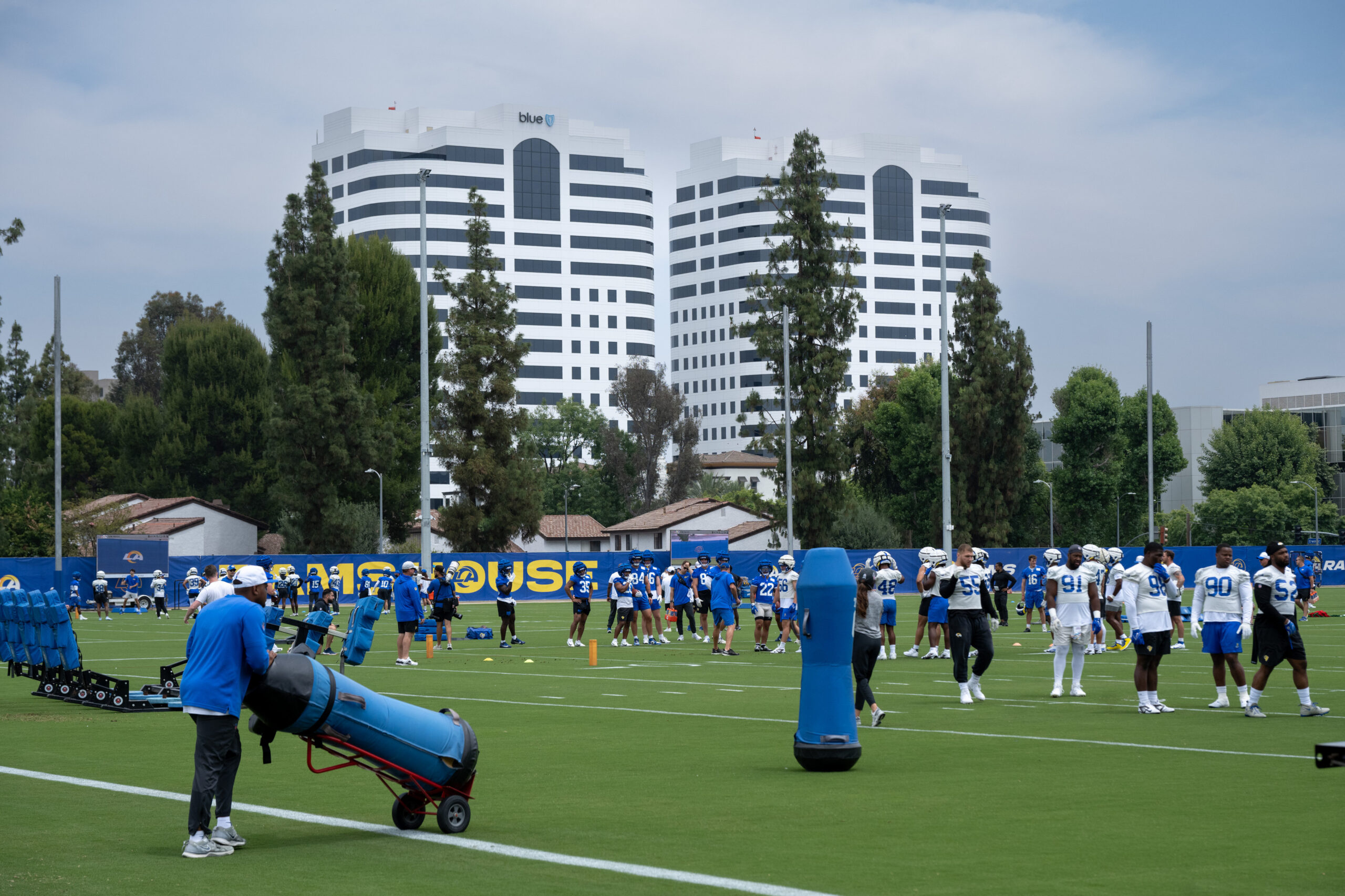 Rams players take the field during an OTA workout on...