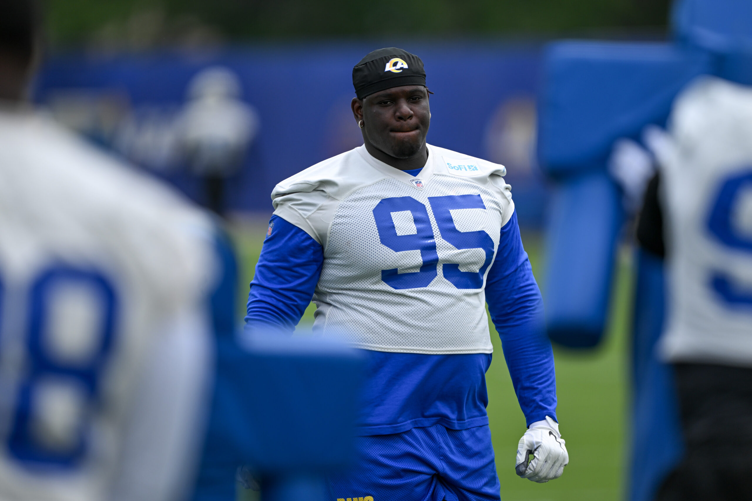 Rams defensive lineman Poona Ford looks on during an OTA...